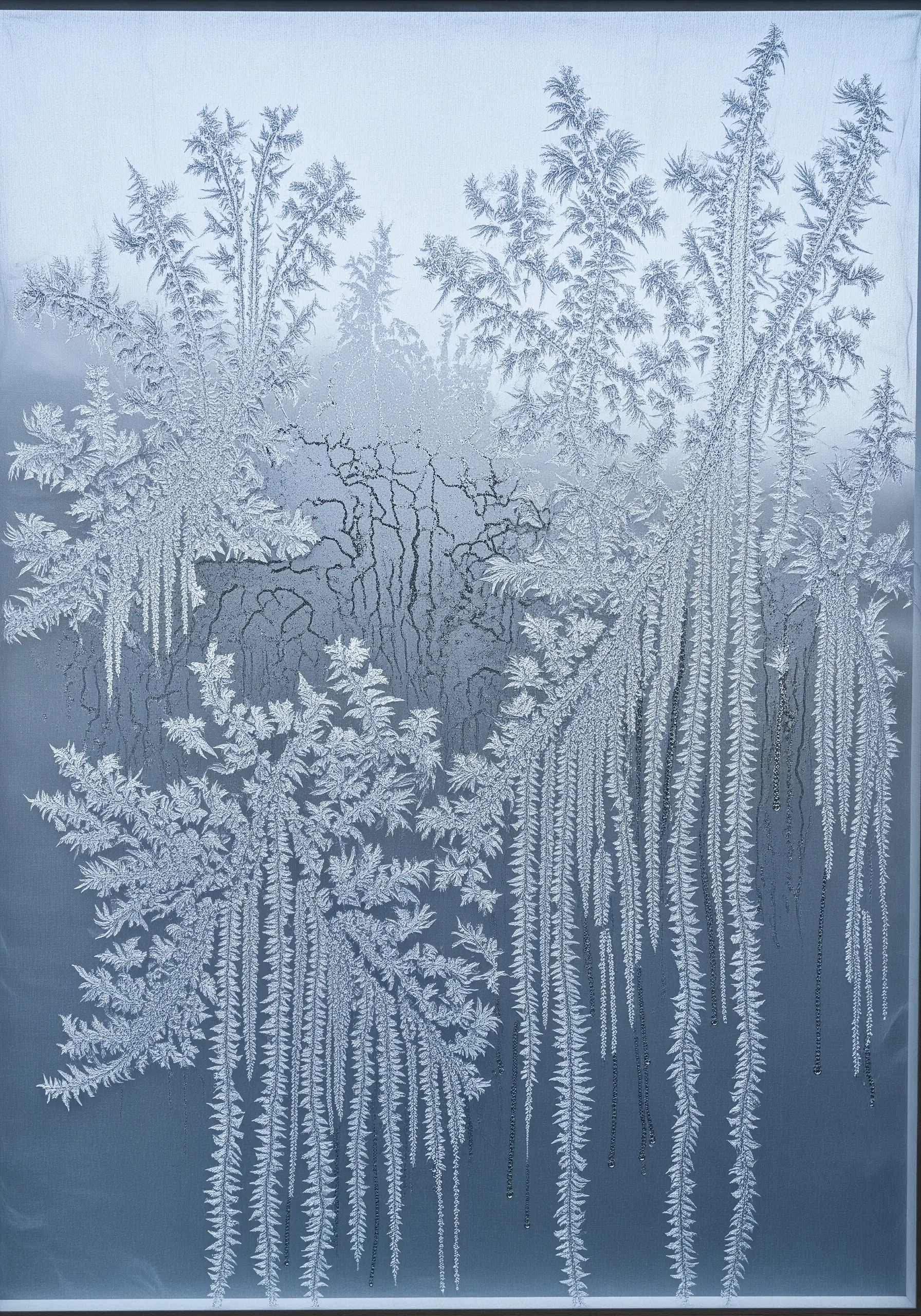 Embroidery on sheer fabric depicting delicate, crystalline frost patterns.
