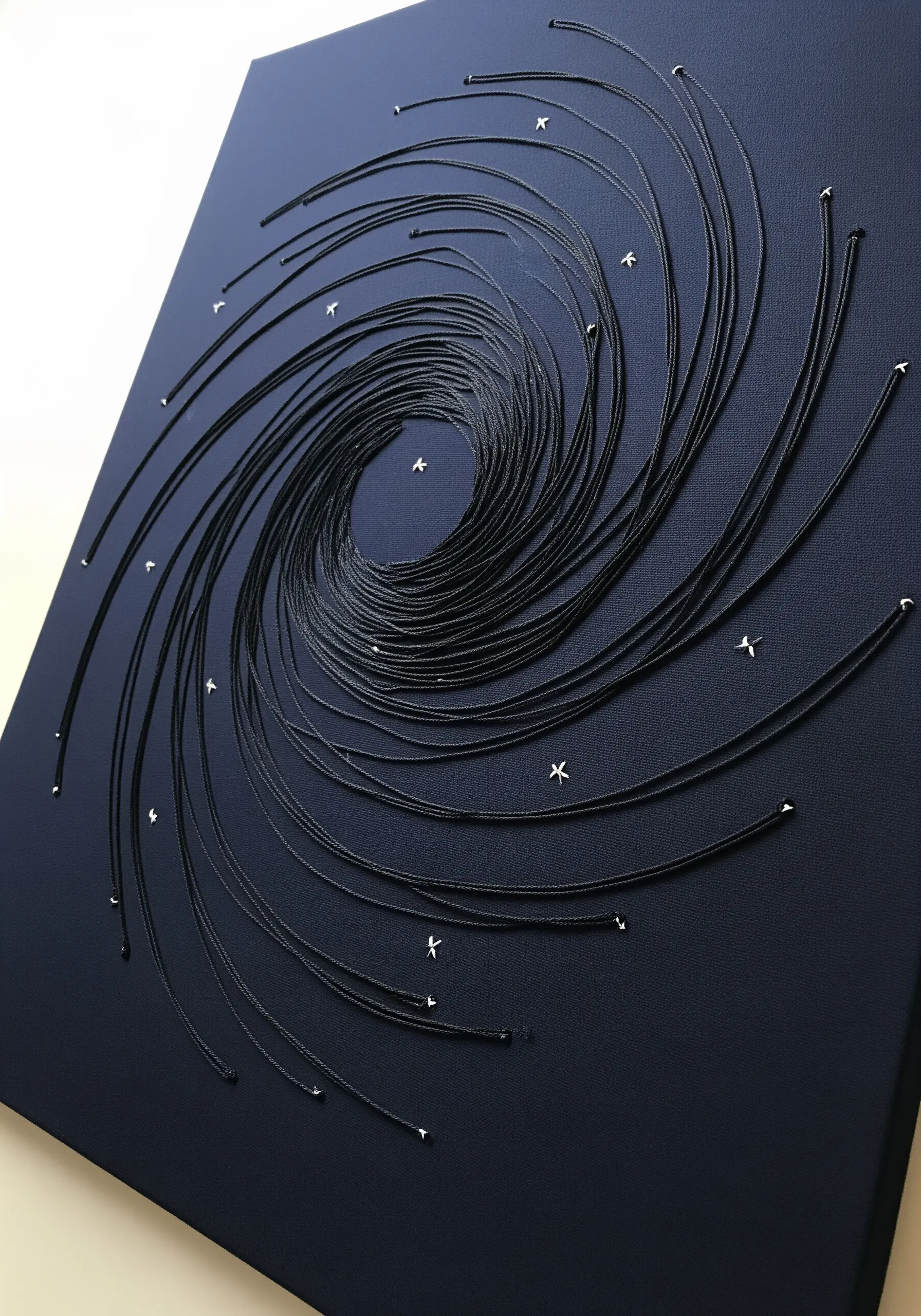3D string art vortex made with black thread and pins on a dark canvas.