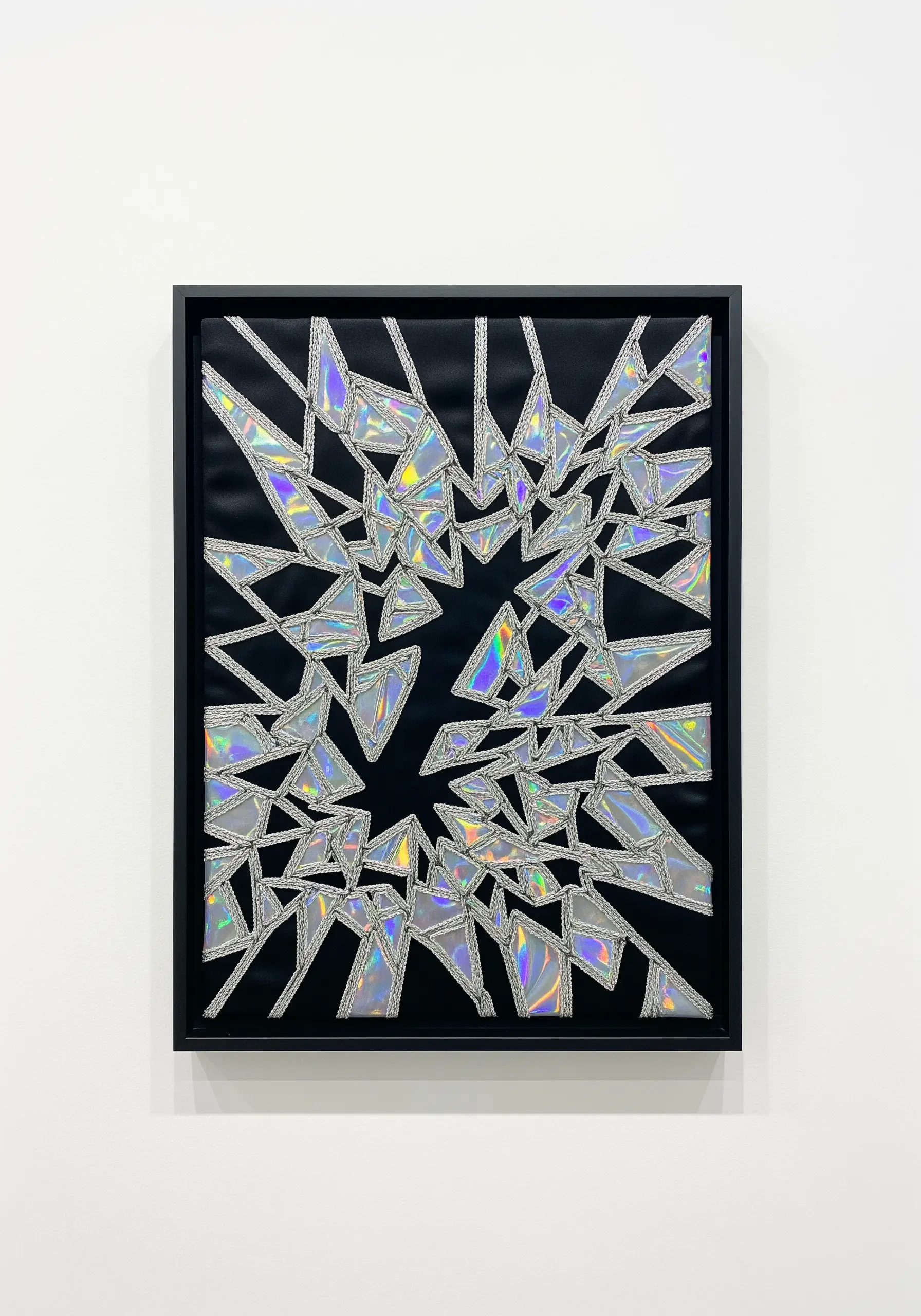 Framed abstract art made of shattered holographic appliqué stitched with silver metallic thread.