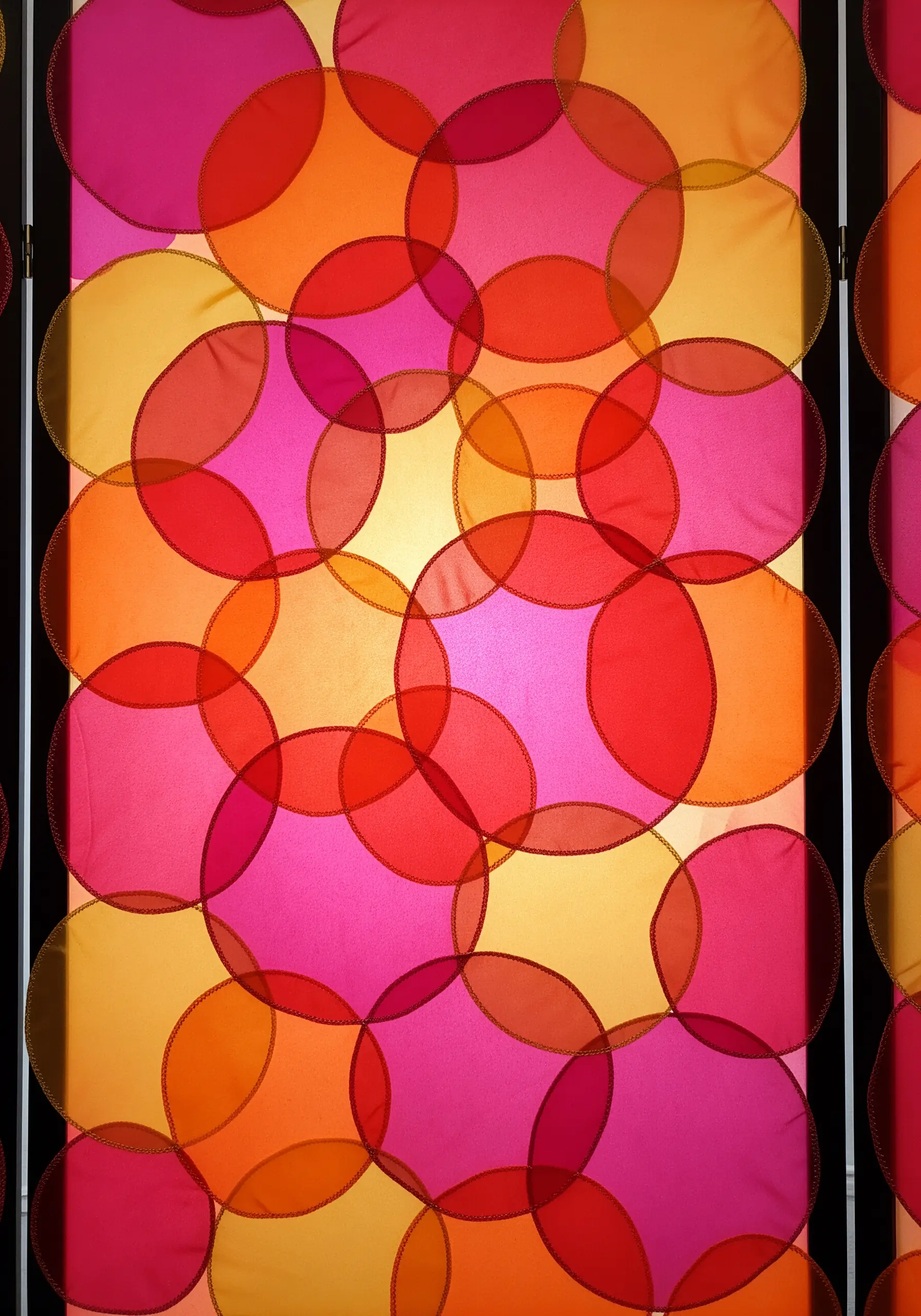 A panel of overlapping sheer circles in magenta, orange, and yellow, demonstrating color blending.