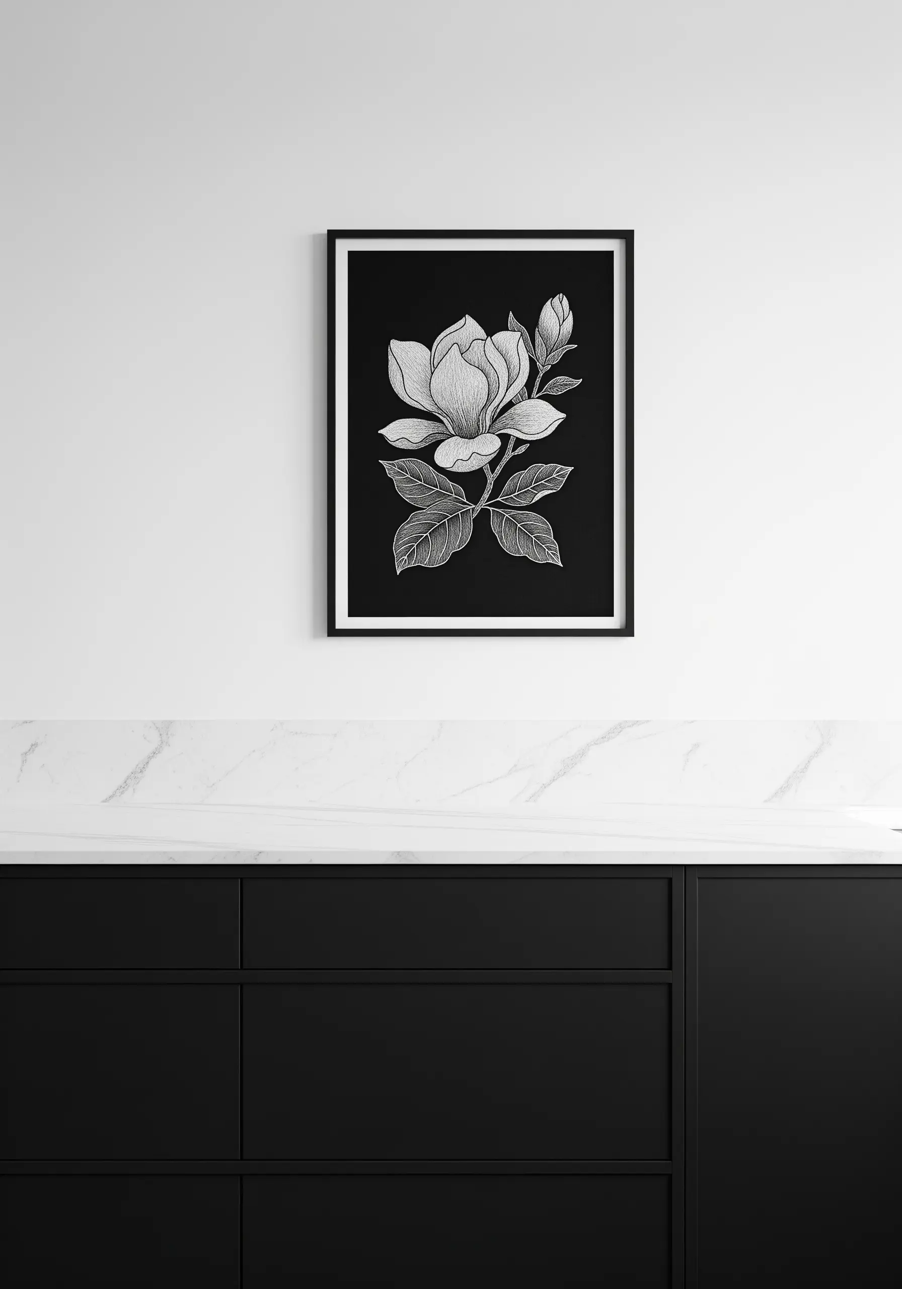 A large framed monochrome embroidery of a magnolia flower in white thread on black fabric.