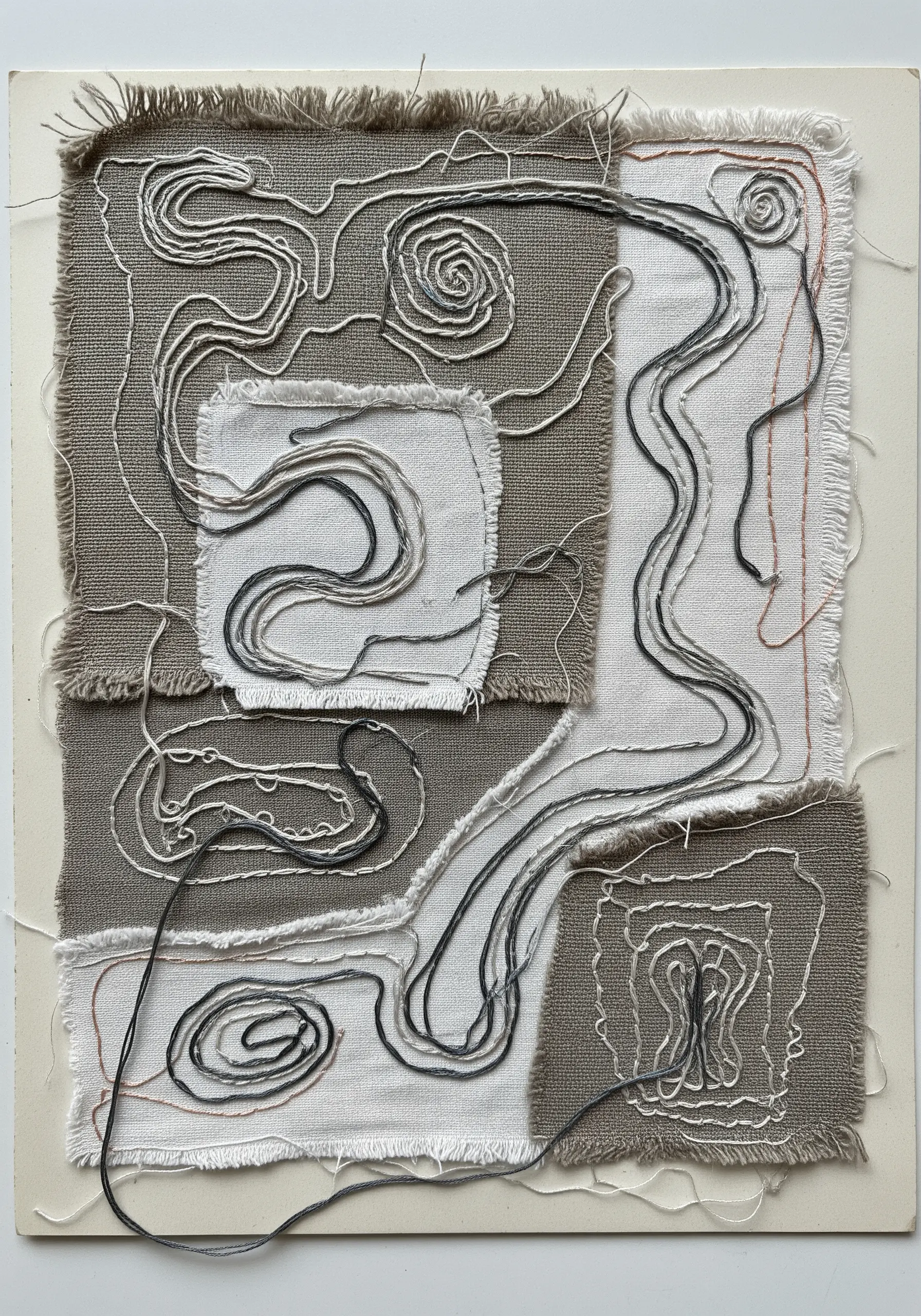 Abstract collage of neutral fabrics stitched with free-motion machine embroidery lines.