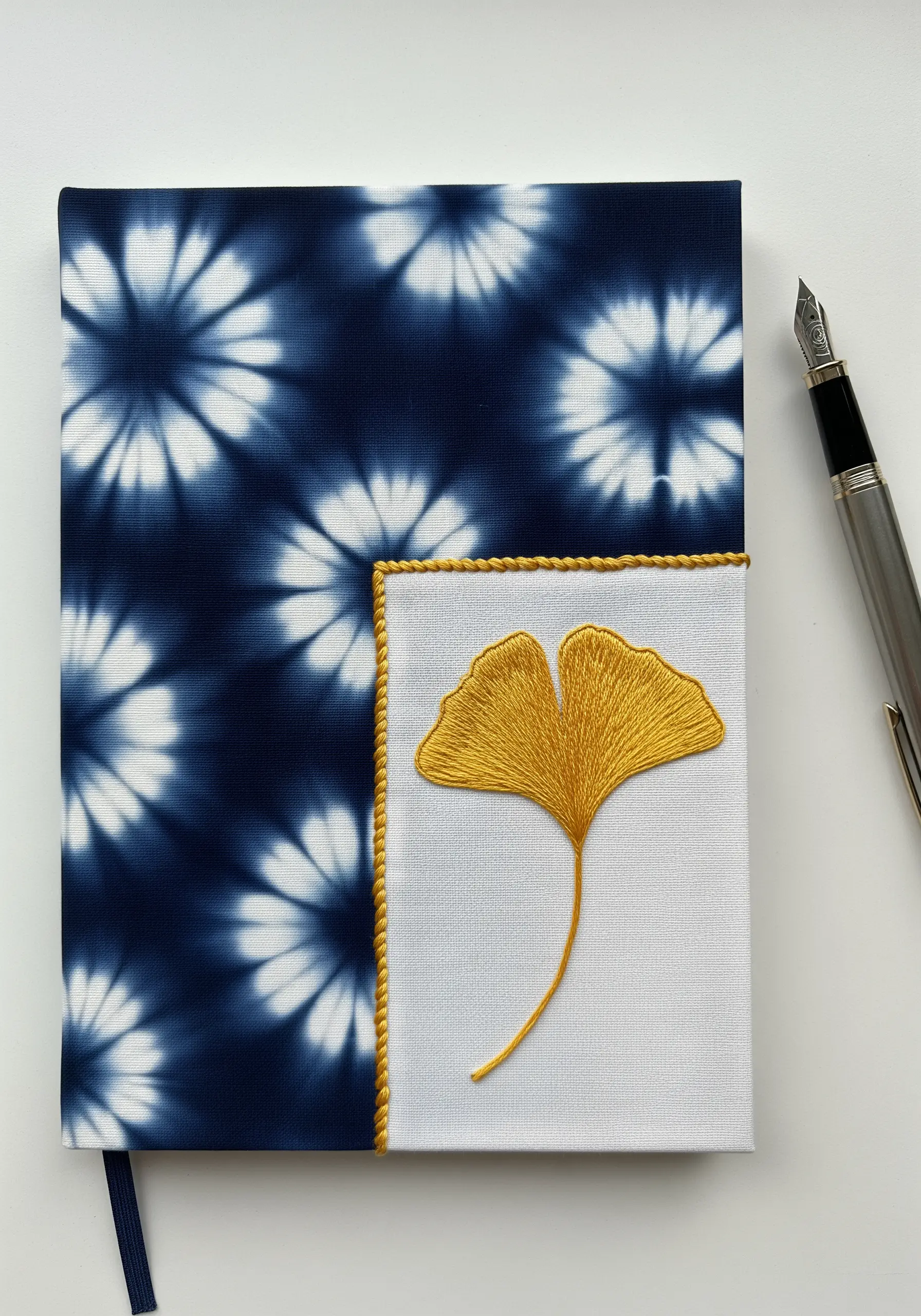Notebook with a shibori-dyed cover and an embroidered ginkgo leaf panel.