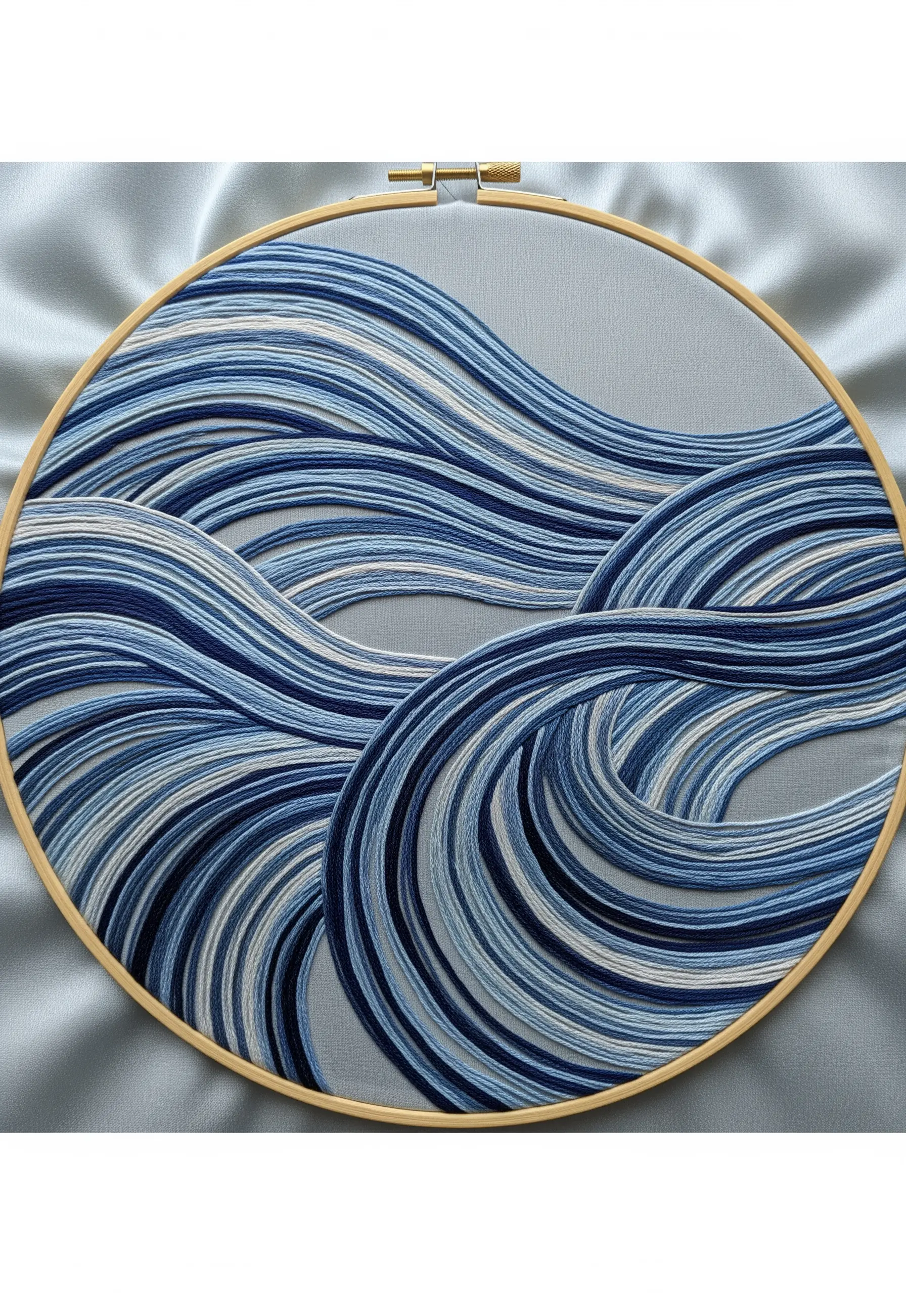 Embroidery hoop filled with abstract flowing waves in multiple shades of blue thread.