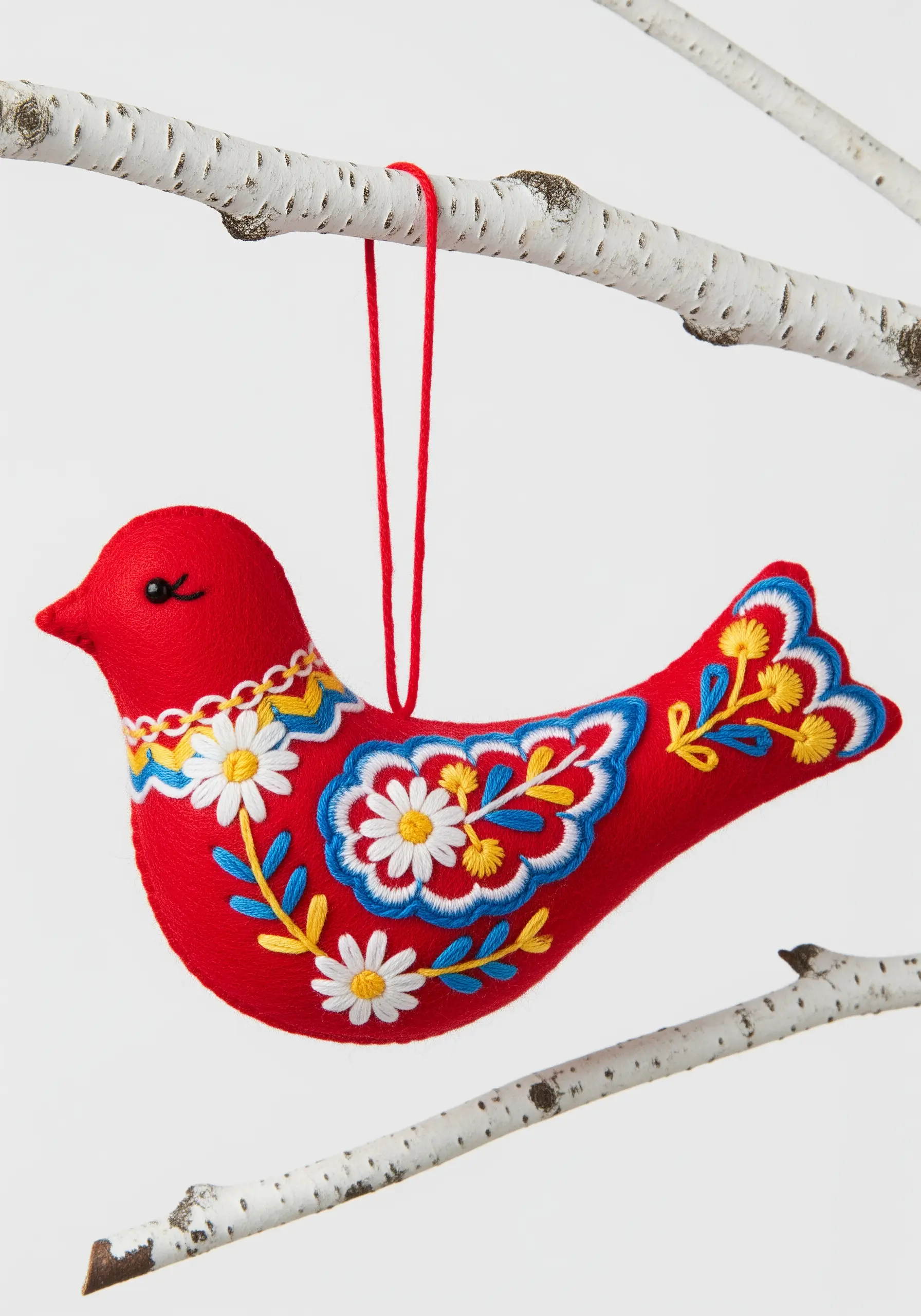 Red felt bird ornament with colorful folk art floral embroidery.
