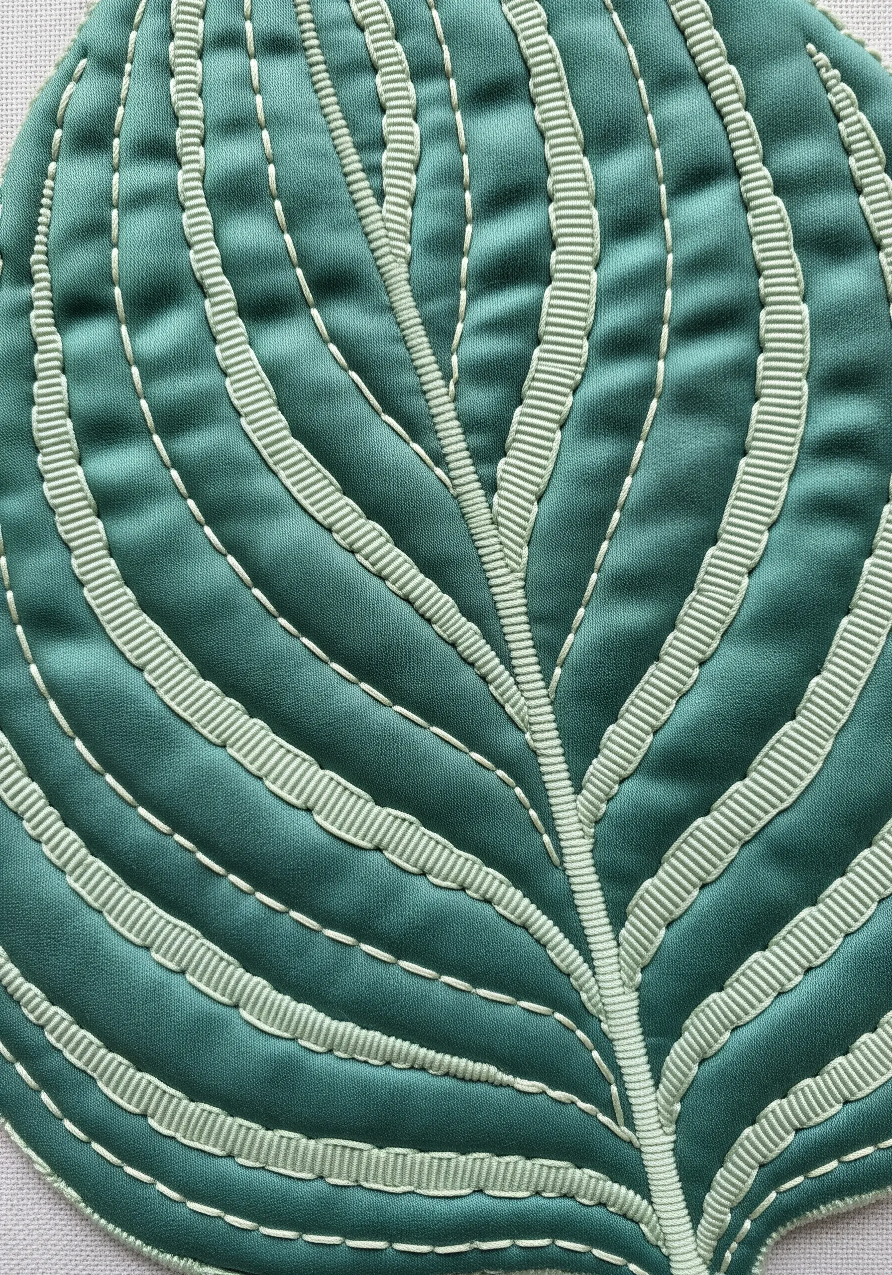 A green leaf motif where the veins are created with applied pale green ribbon.