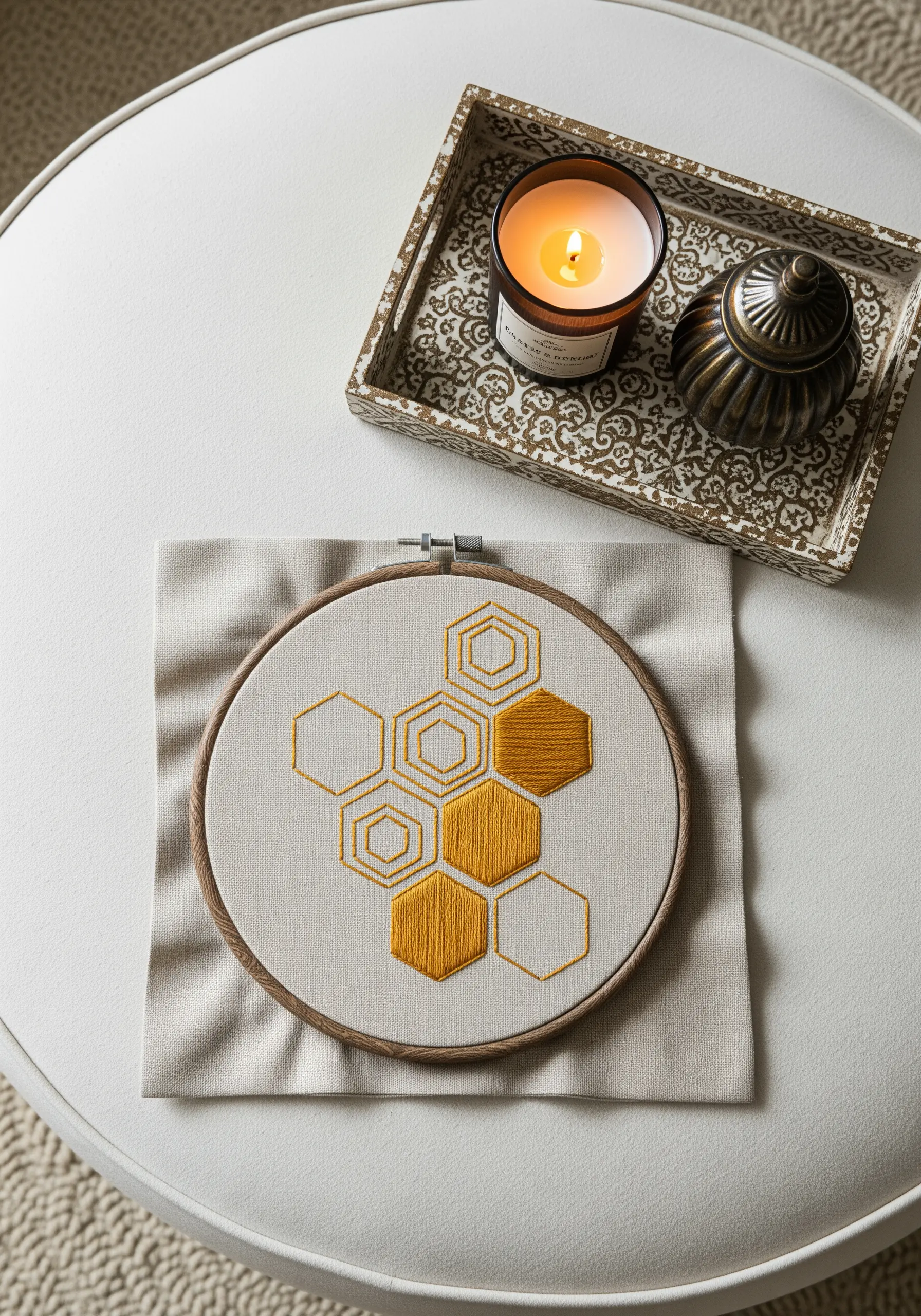 Honeycomb pattern embroidered in gold, with some hexagons filled with satin stitch.