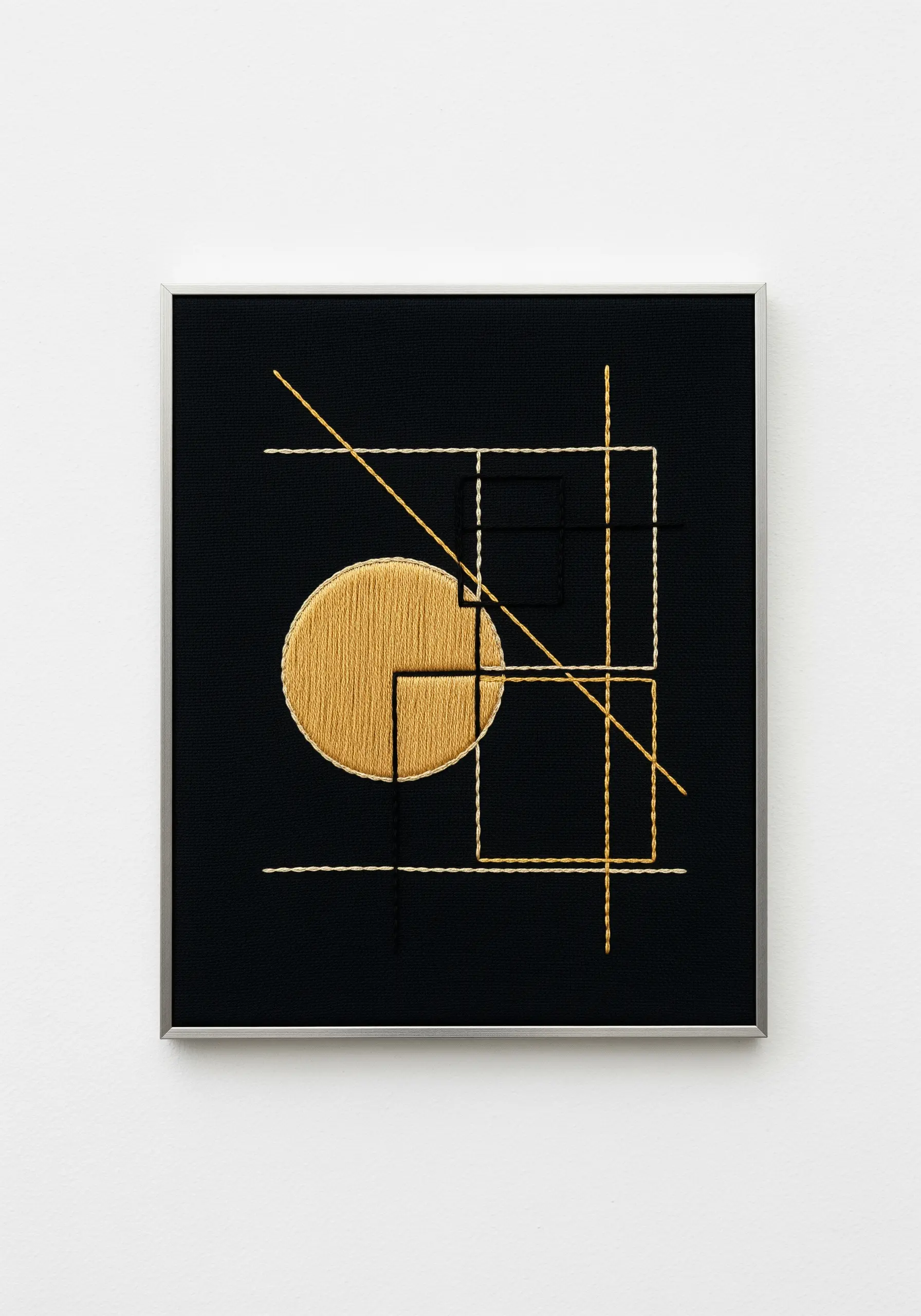 A minimalist geometric design with a gold satin-stitched circle and fine lines.