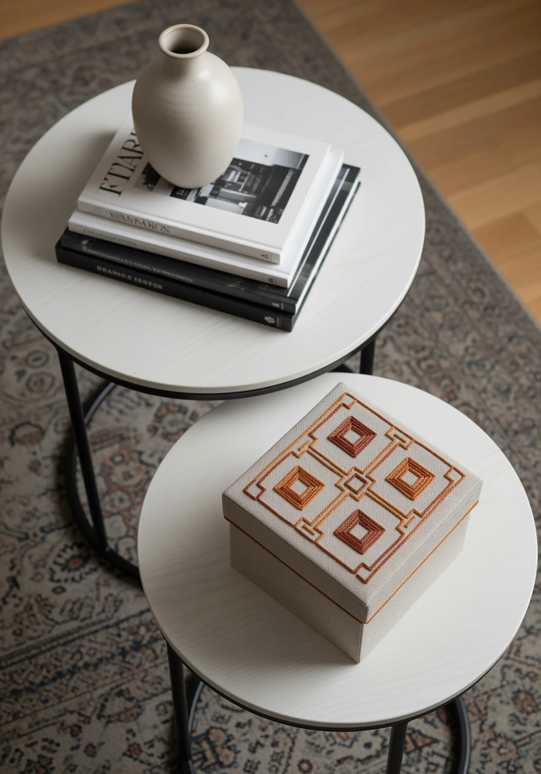 A fabric-covered box with a geometric pattern embroidered in shades of copper and rust.