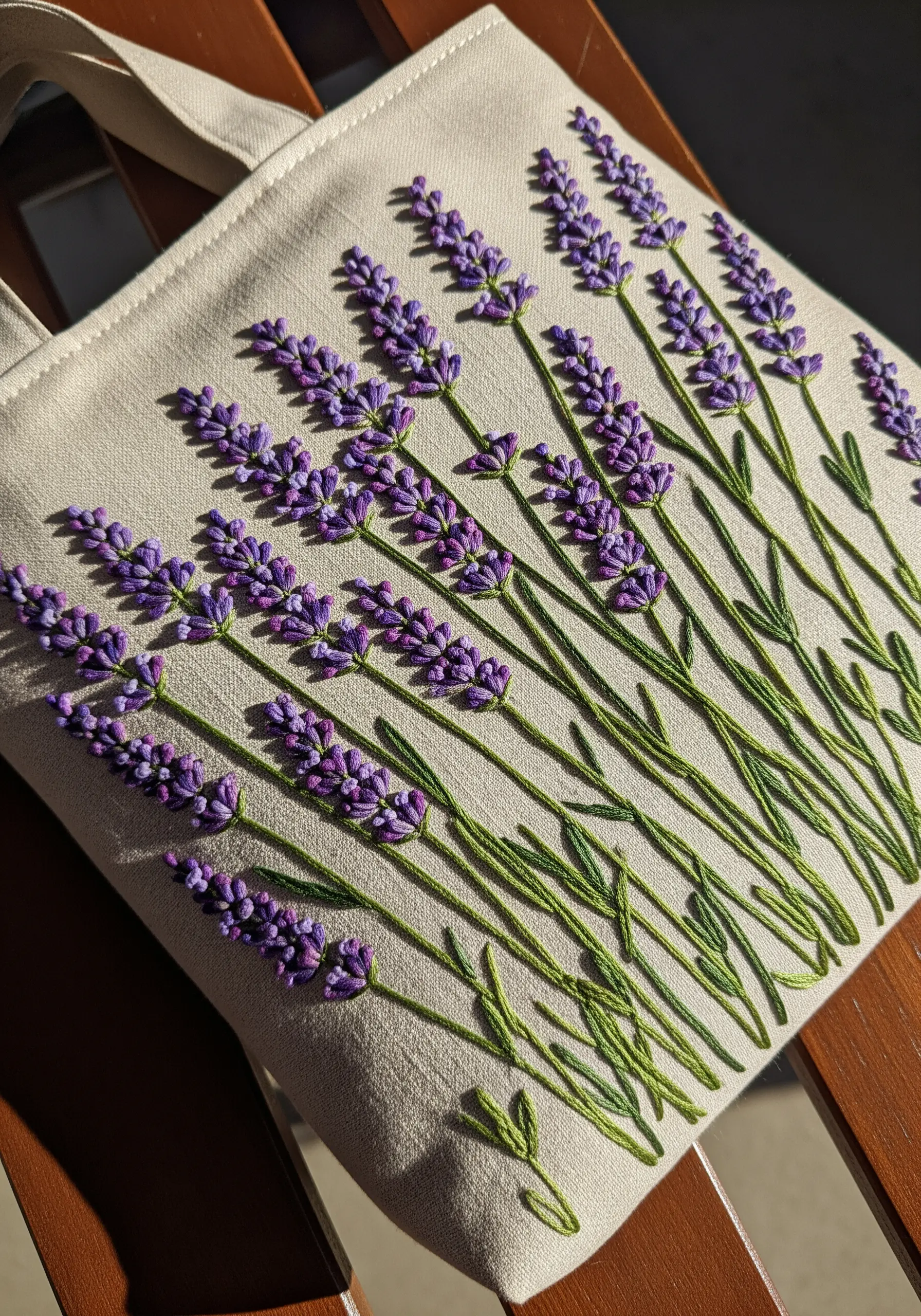 A canvas tote bag embroidered with realistic lavender sprigs using bullion knots for the blossoms.