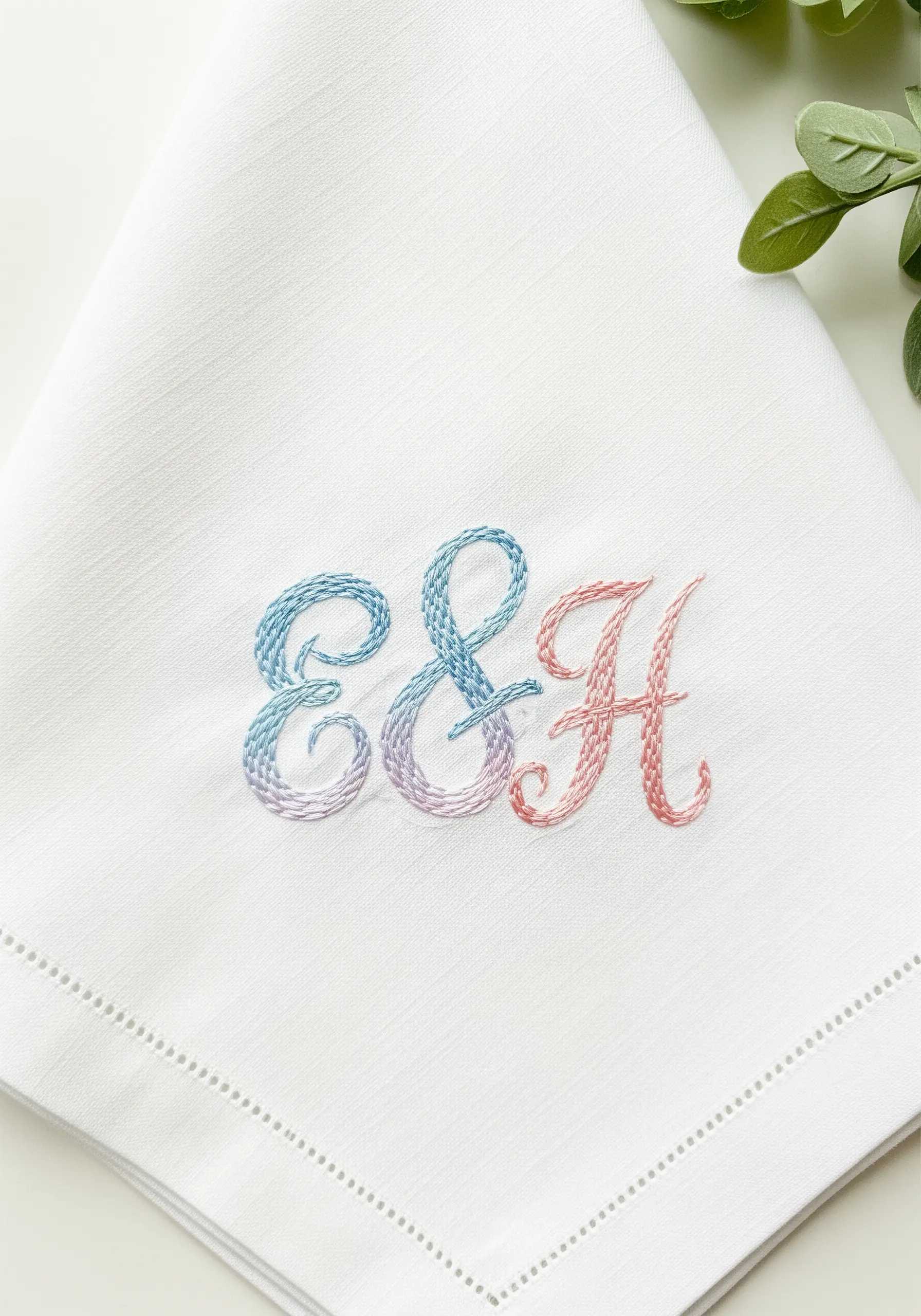 Two initials, E and H, connected by an ampersand with a blue-to-pink color gradient.