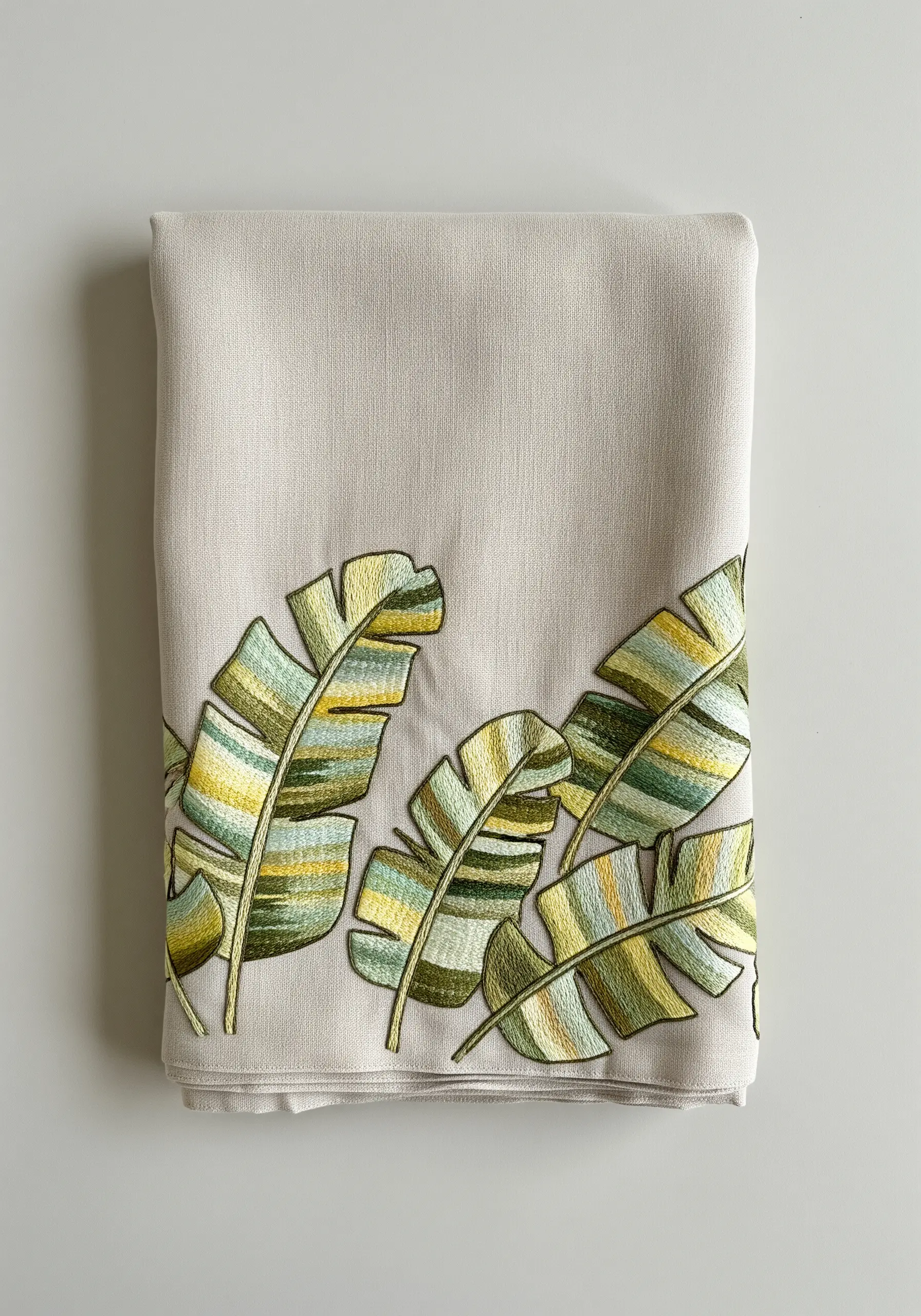 Banana leaves embroidered with variegated thread creating natural green and yellow stripes.