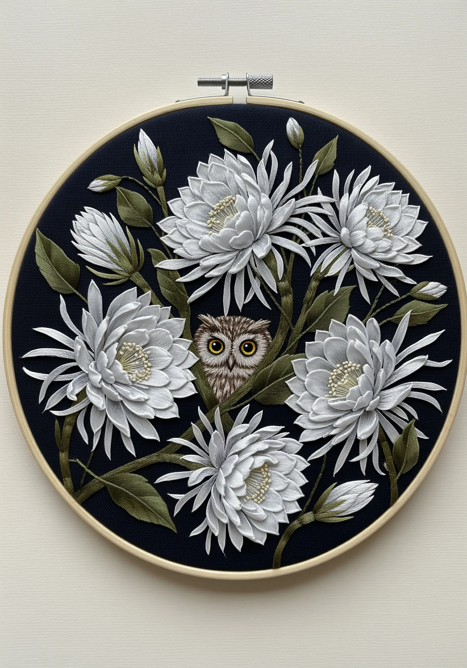 A small owl's face peeking out from behind a dense bouquet of 3D embroidered white flowers.