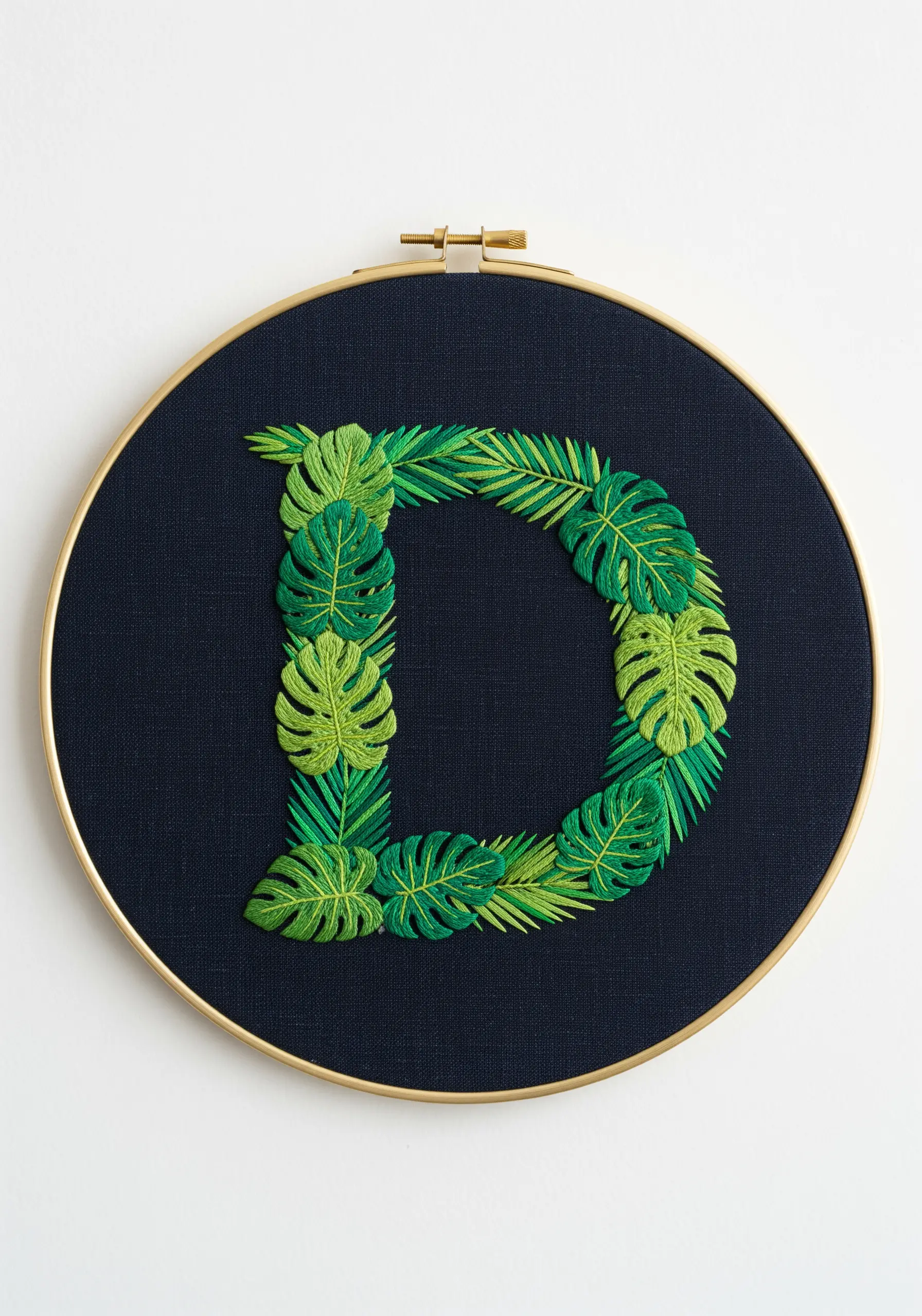 Vibrant green tropical leaves like monstera forming the letter D on a dark navy background.