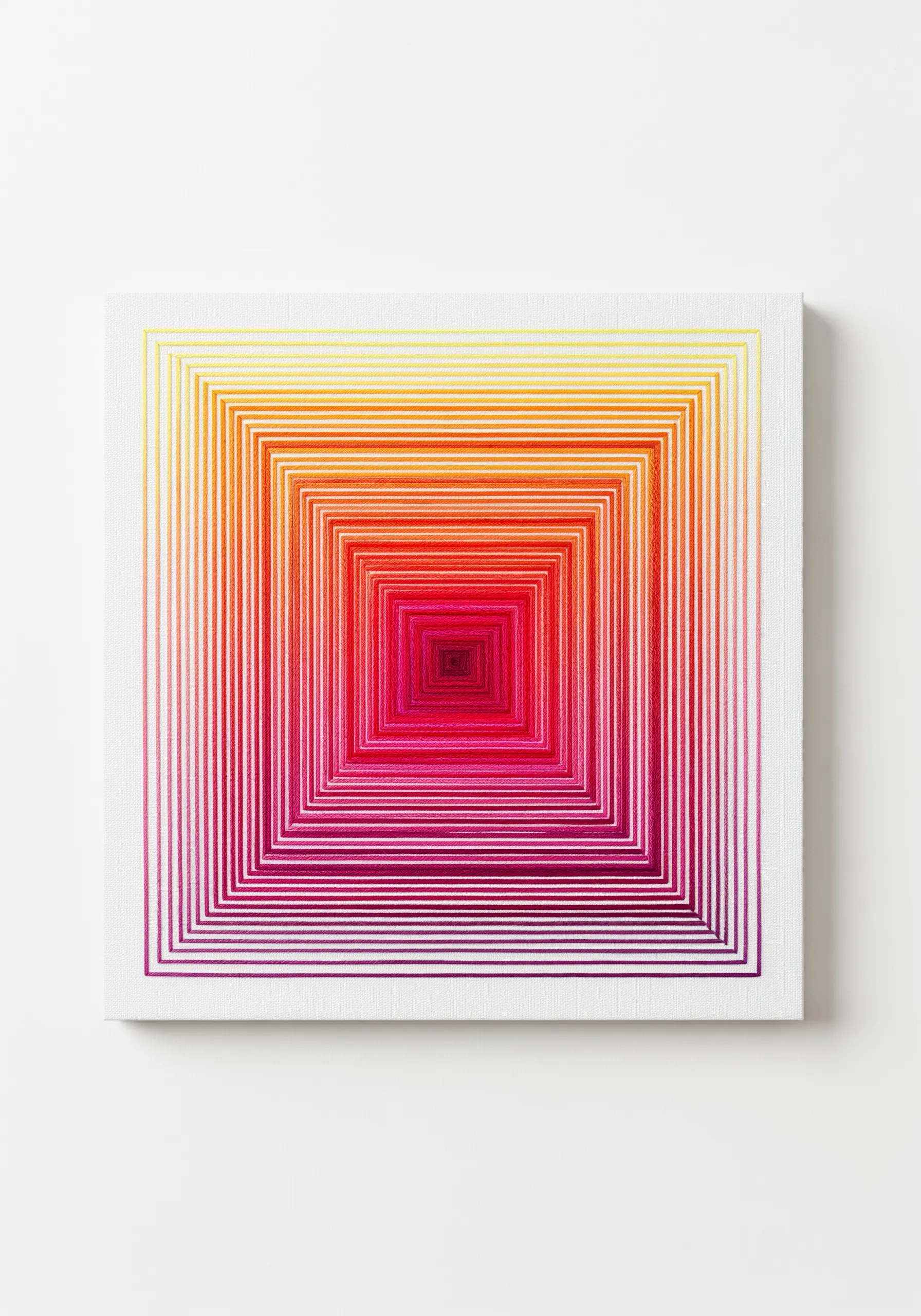 Concentric squares embroidered in a vibrant rainbow gradient, creating an optical illusion.