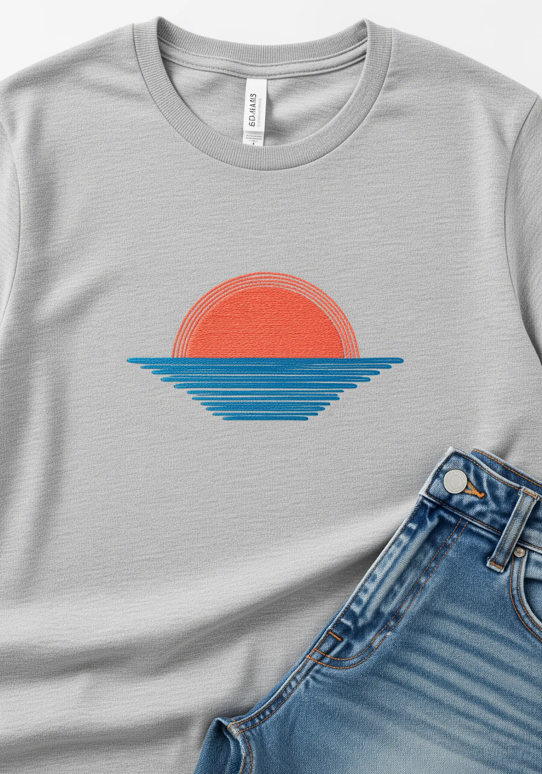 A minimalist sunset over water, created with parallel lines of orange and blue thread on a shirt.