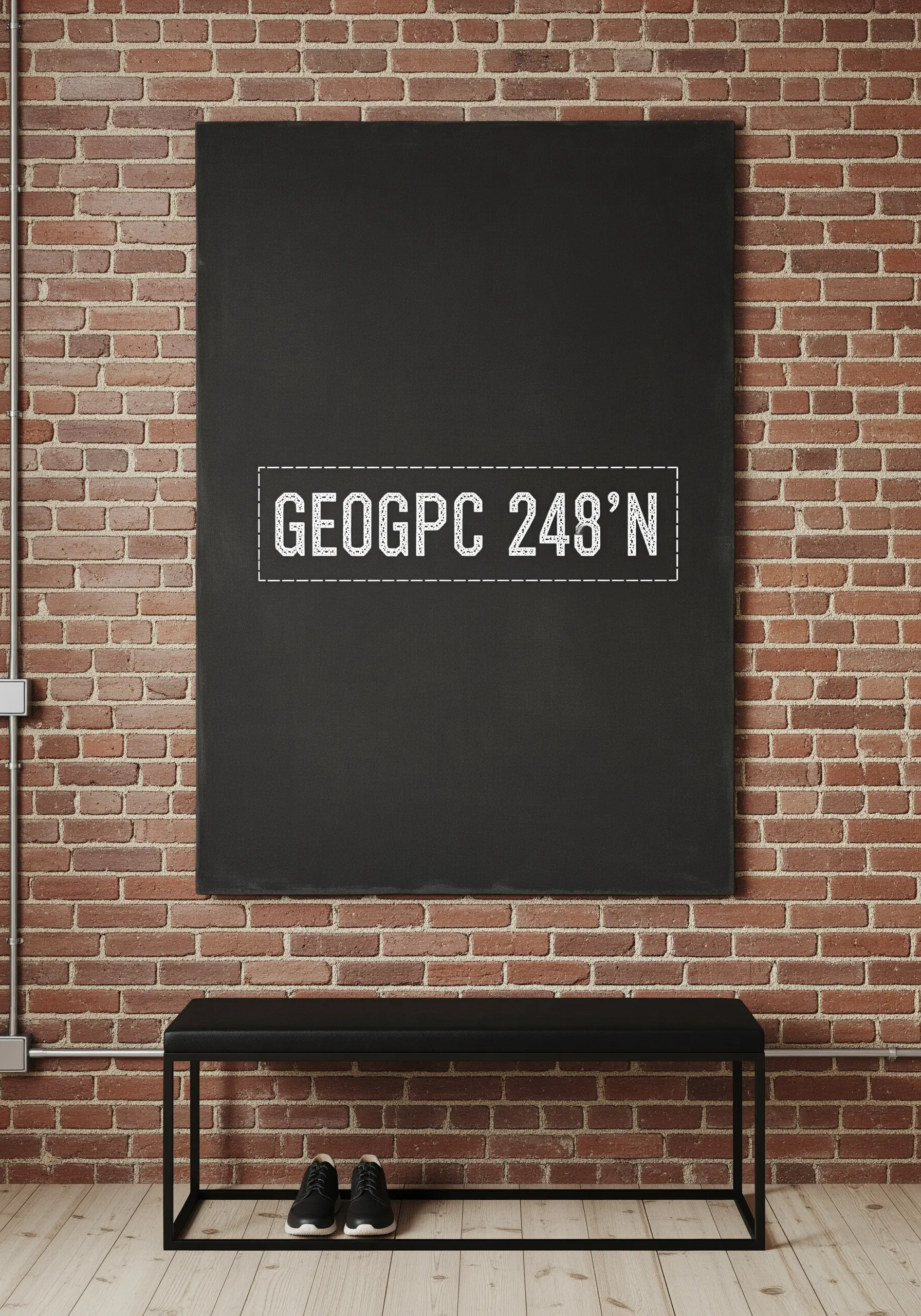 Embroidered geo-coordinates in a white stencil font on a large black canvas.