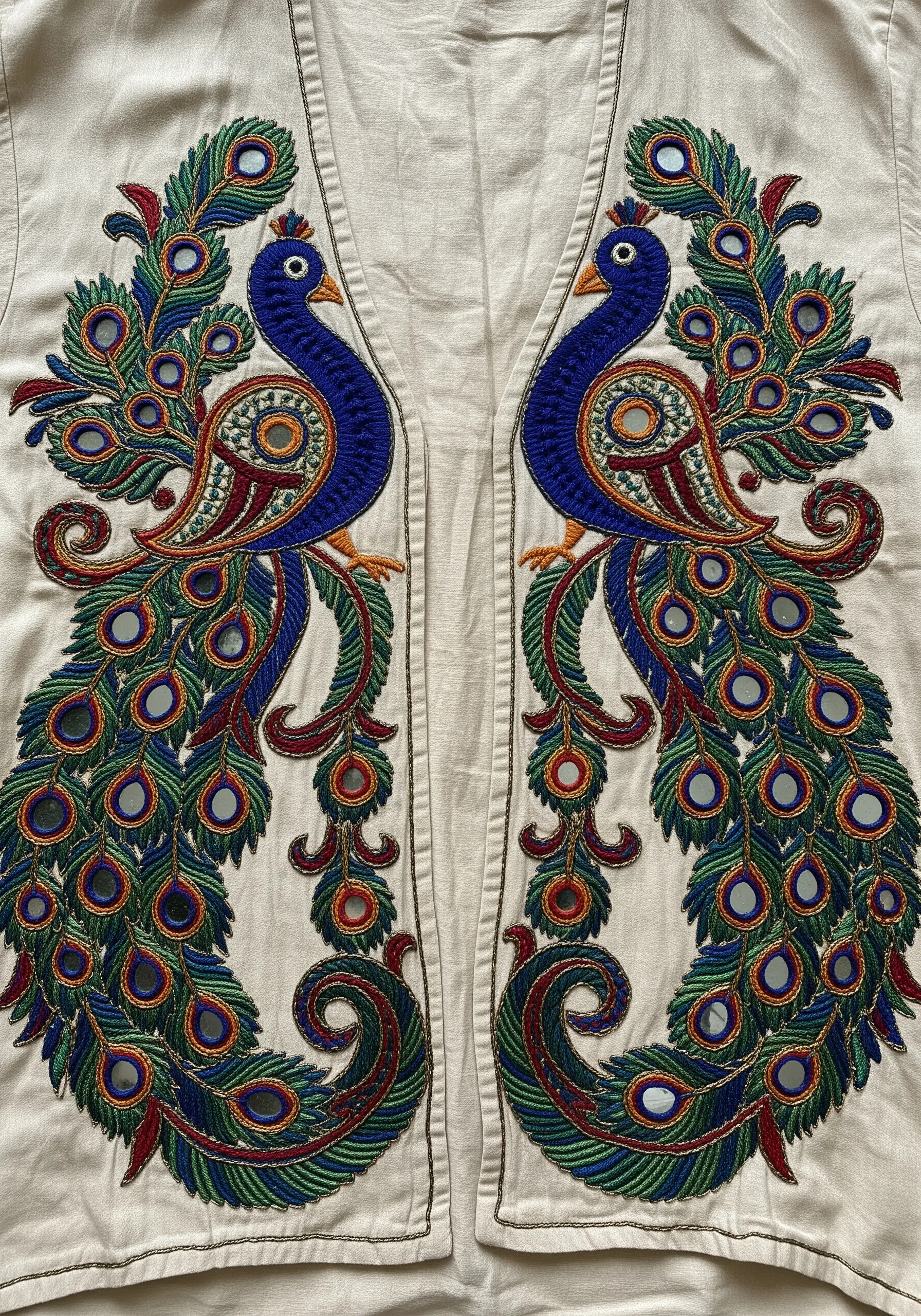 Symmetrical embroidered peacocks featuring small, round Shisha mirrors in the tail feathers.