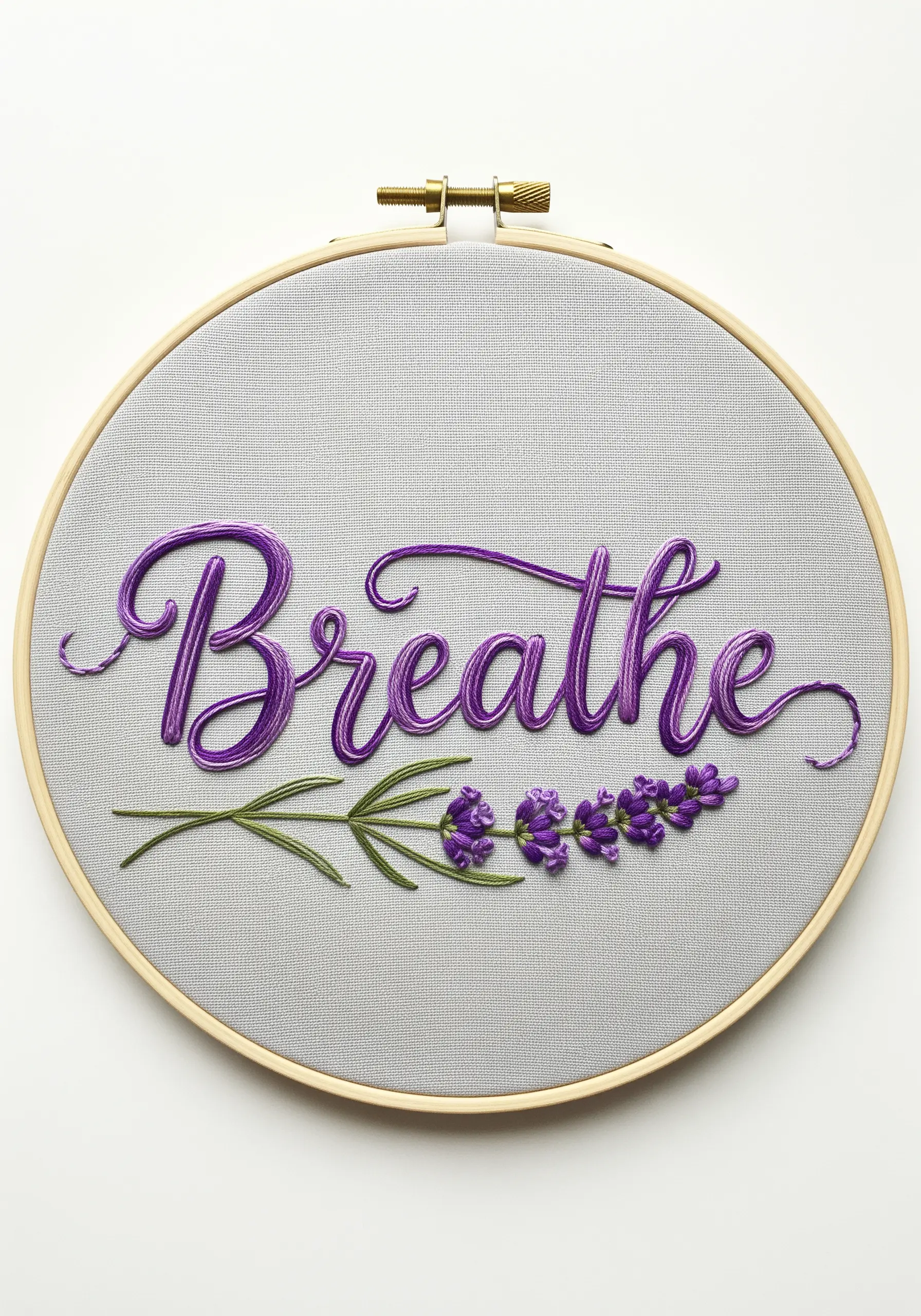 The word 'Breathe' embroidered in cursive script with a lavender sprig underneath.