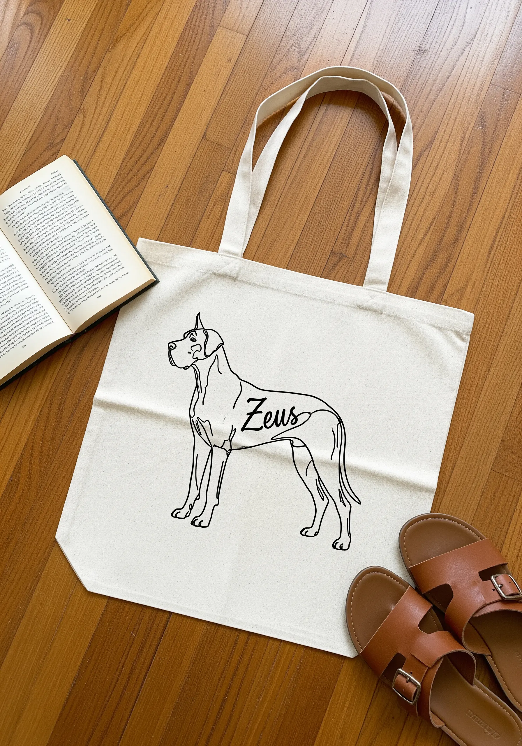 Line art of a Great Dane on a tote bag with the name 'Zeus' integrated.
