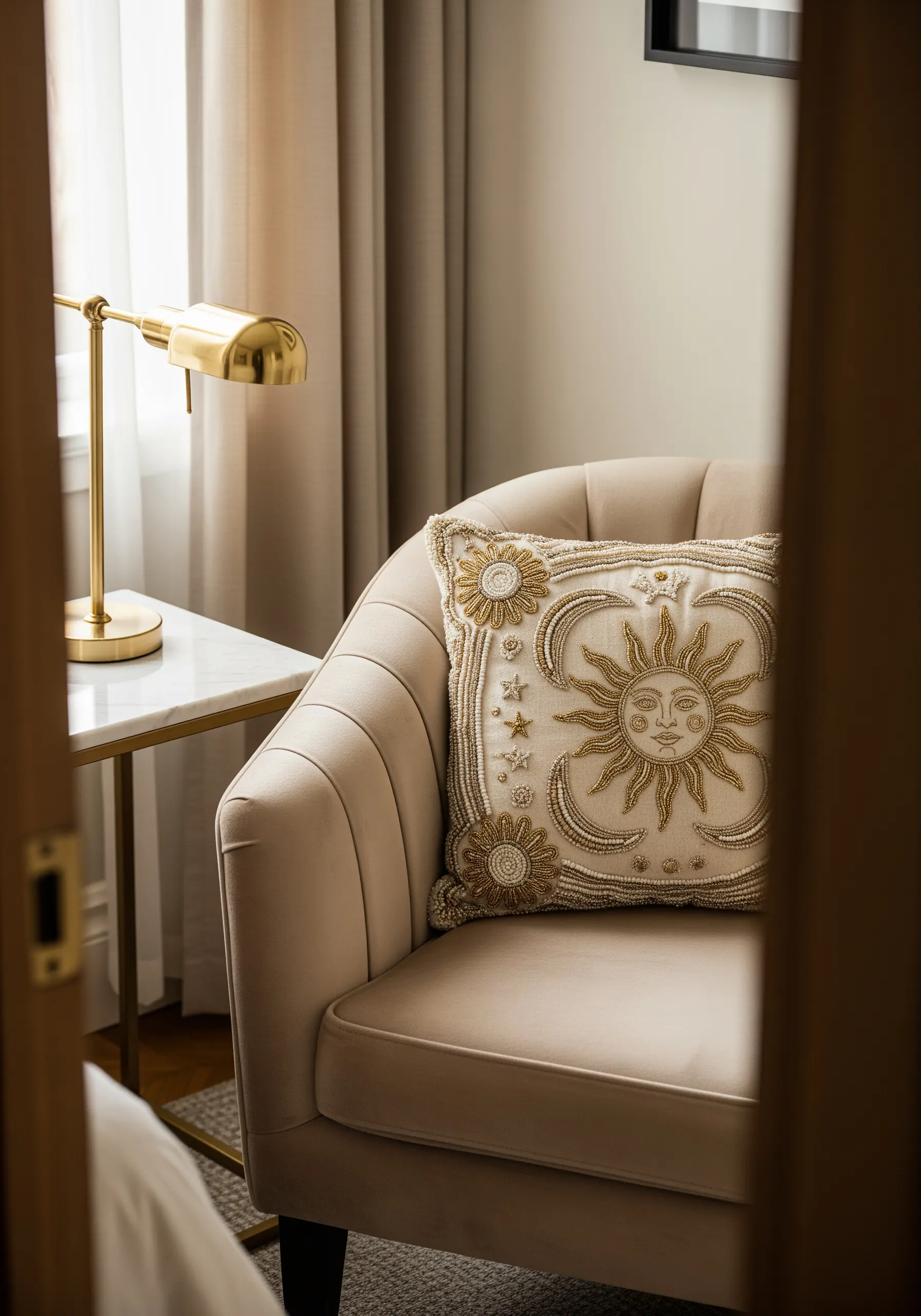 A celestial sun motif embroidered with gold metallic thread and beads.