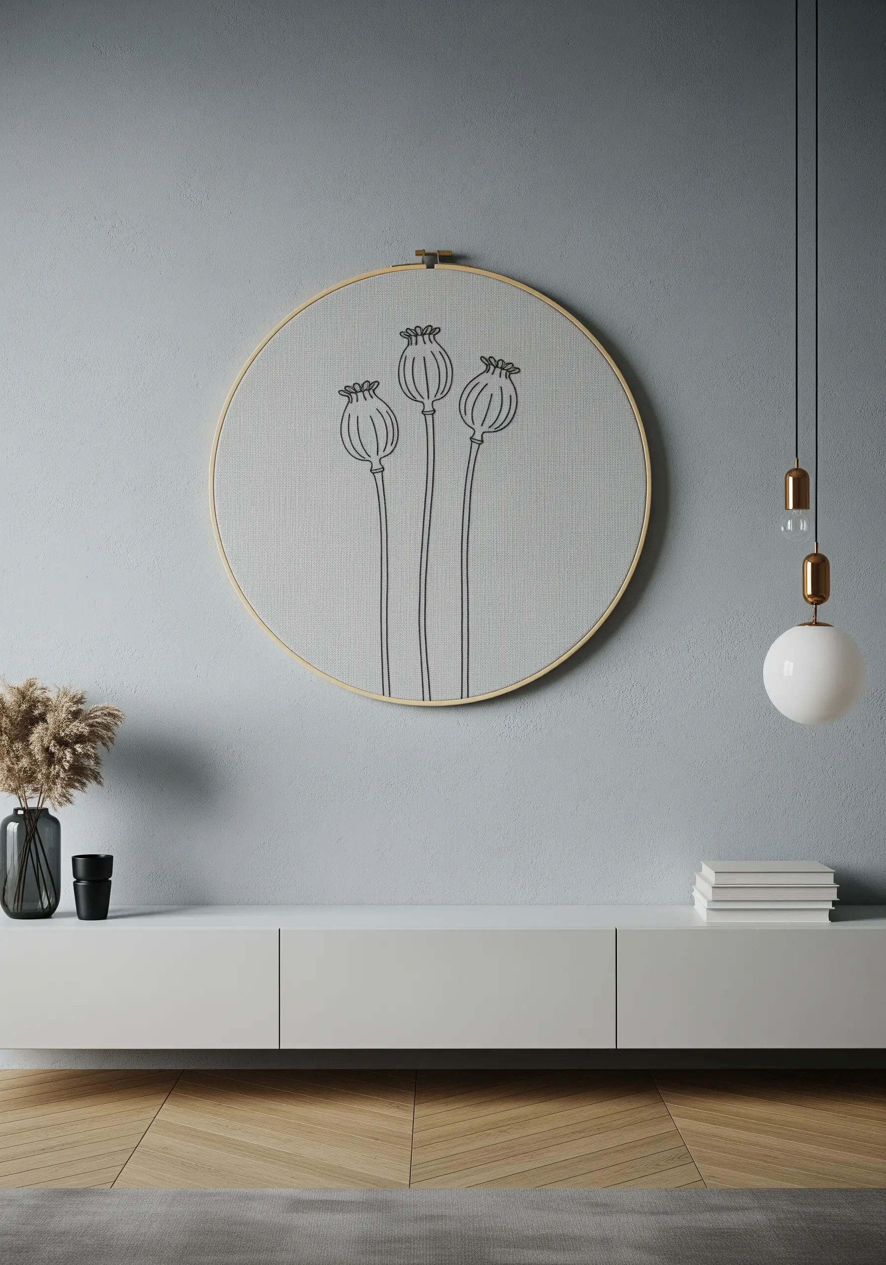 Minimalist line art embroidery of three poppy seed heads in a large hoop.