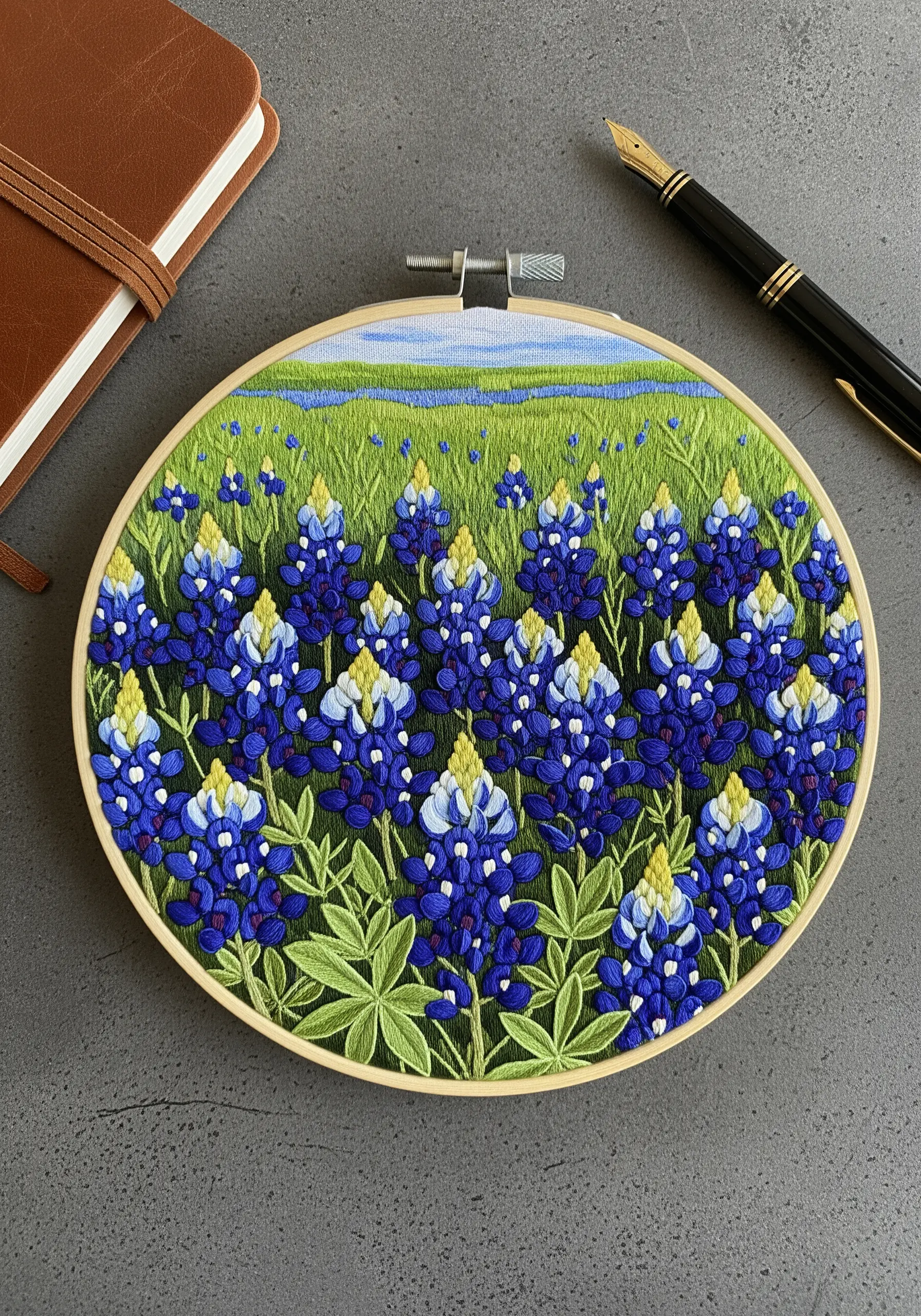 Embroidery of a field of Texas bluebonnets with layered stitches for floral texture.