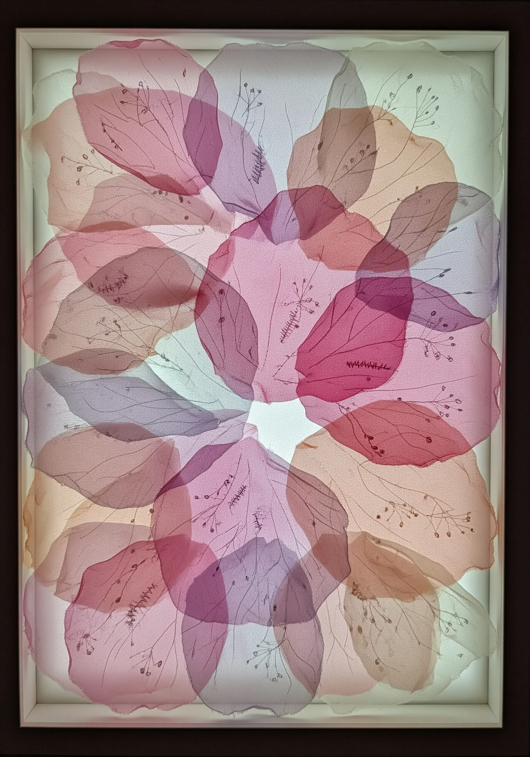 Abstract floral art made from layered, translucent pink and purple organza petals in a lightbox