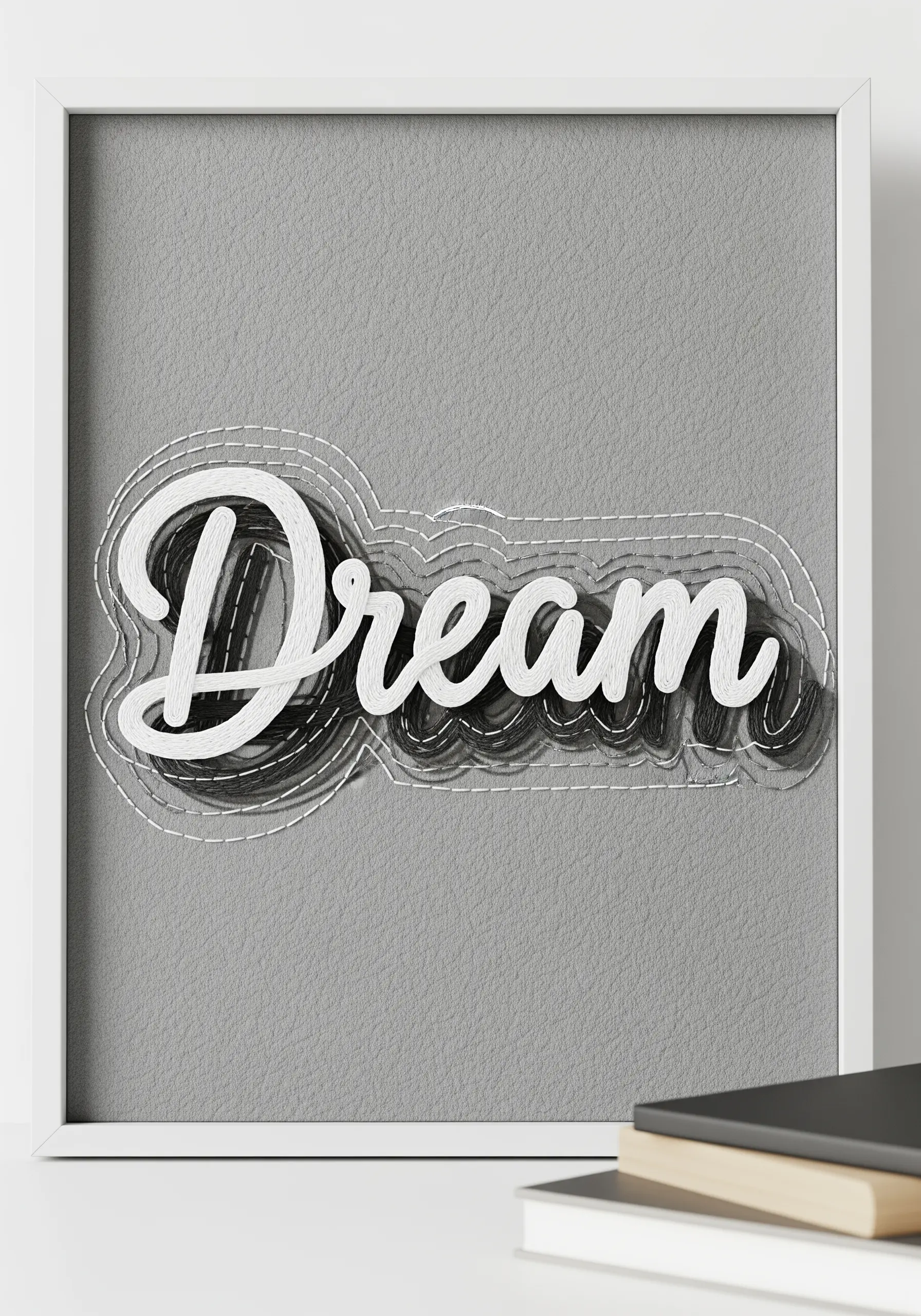 The word 'Dream' in white script over an abstract background of black and grey threads.