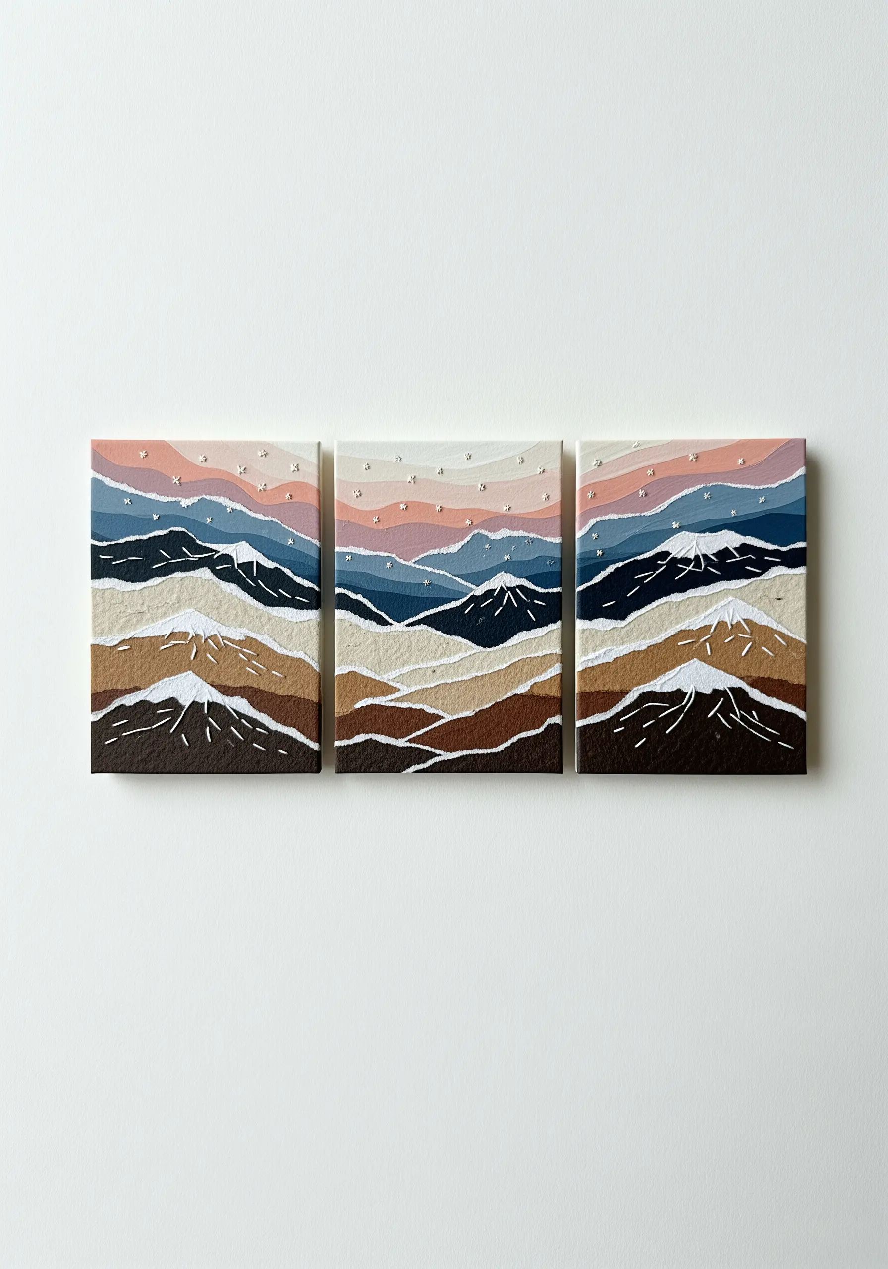 Triptych of a torn paper mountain landscape with stitched white stars.