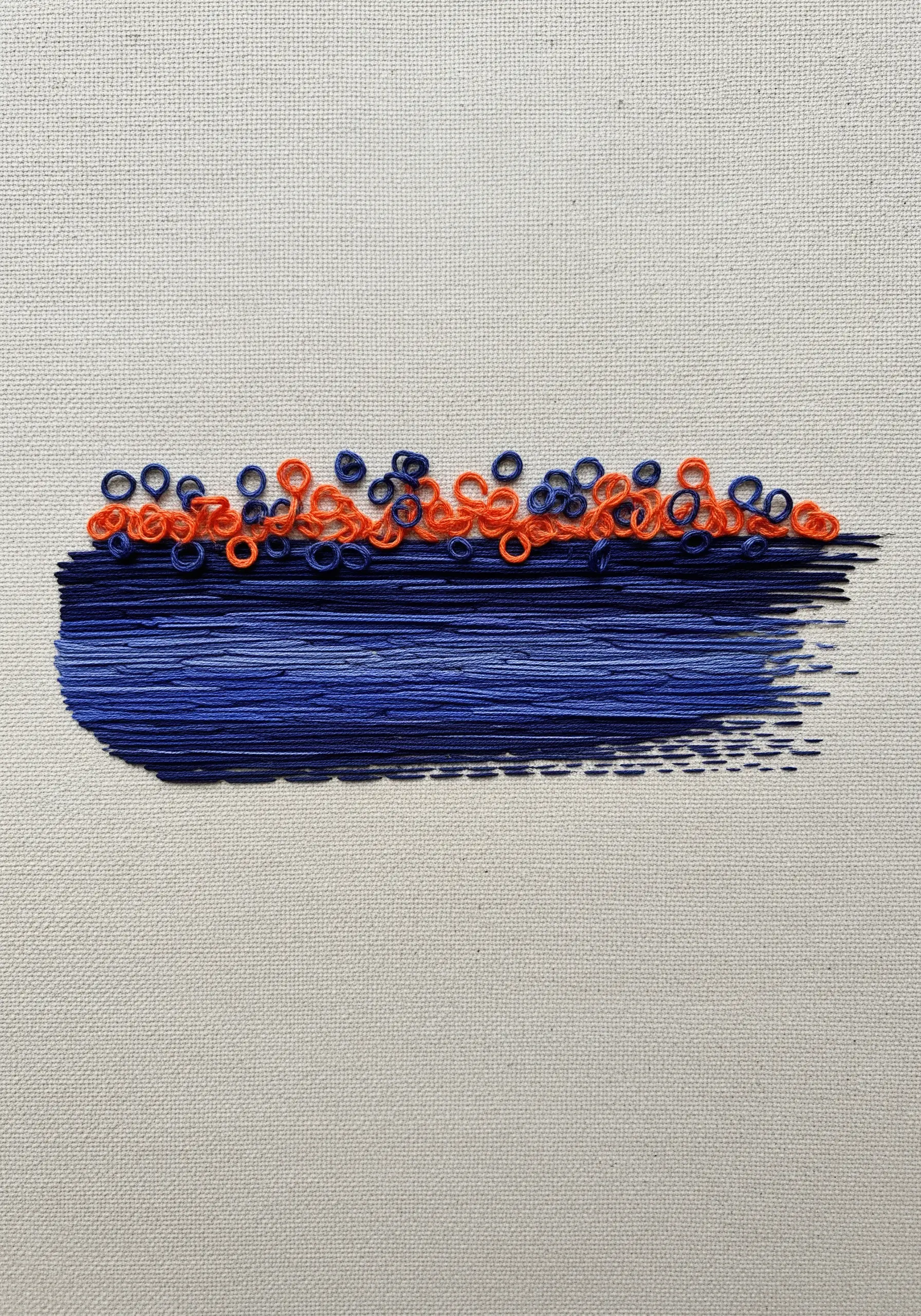 An abstract brushstroke effect made with layered satin stitches in blue, topped with orange rings.
