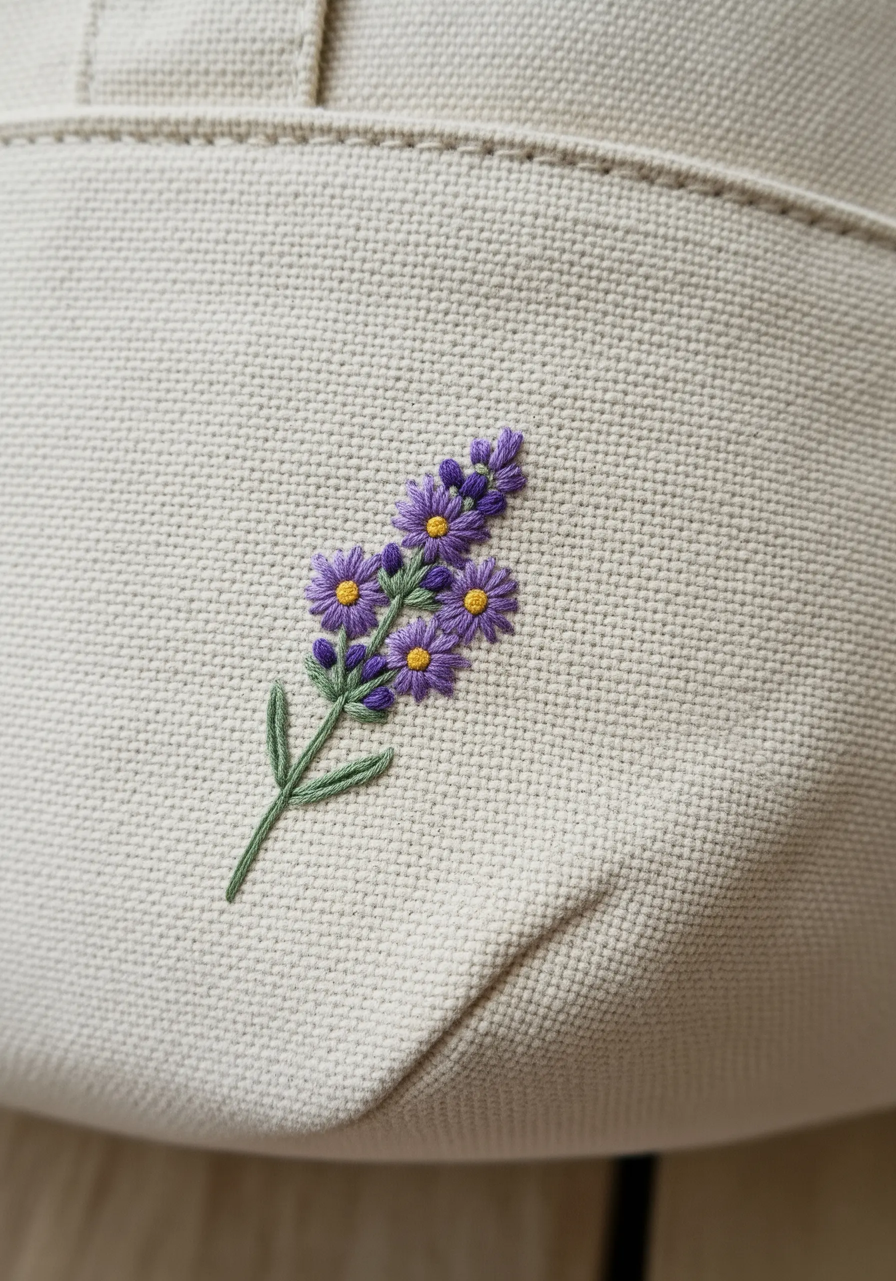 Tiny lavender sprig with purple satin stitch flowers and yellow French knot centers.