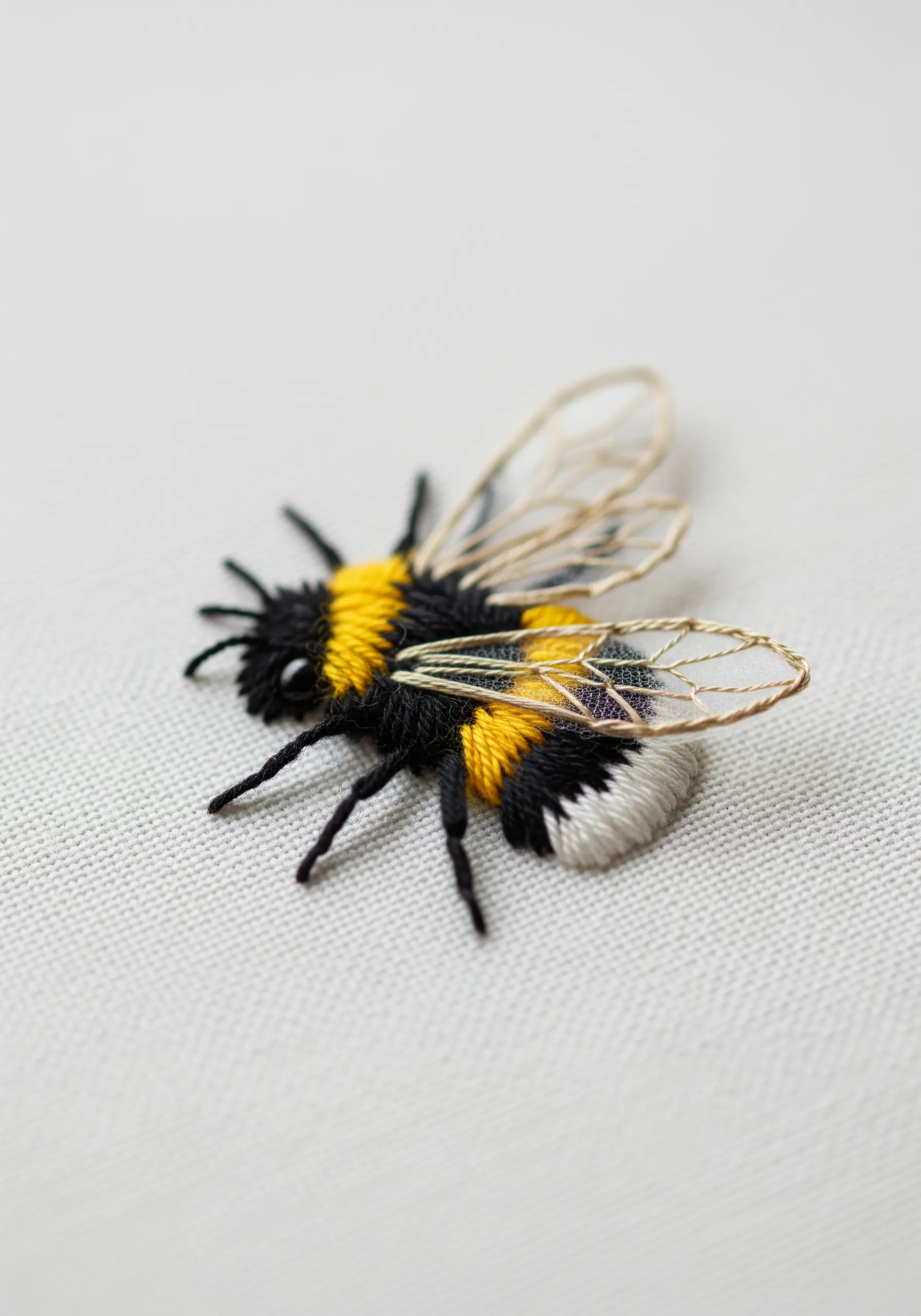 A realistic 3D bumblebee with a fuzzy body and delicate organza wings.
