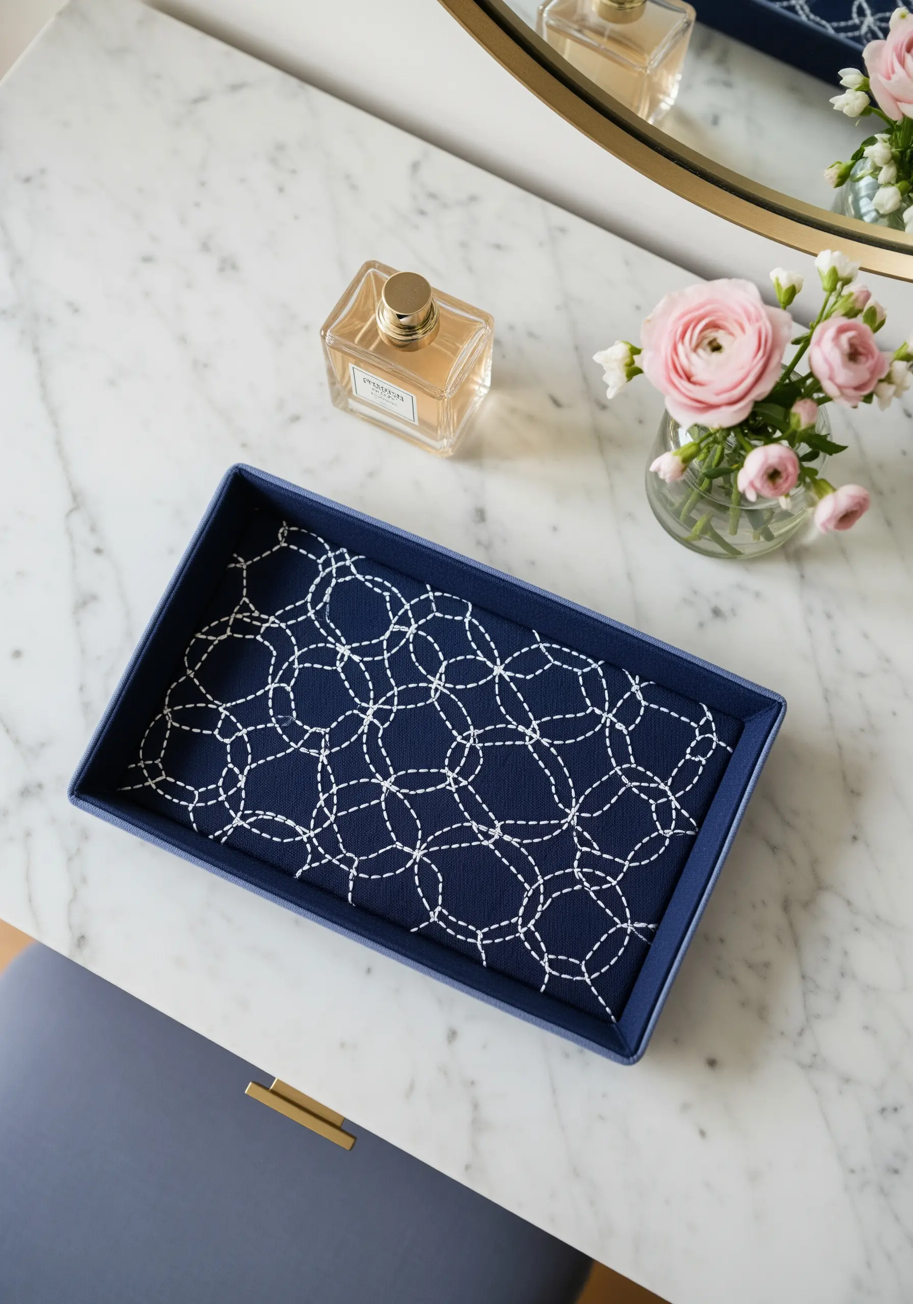 Navy blue valet tray lined with fabric featuring a white sashiko geometric running stitch pattern.
