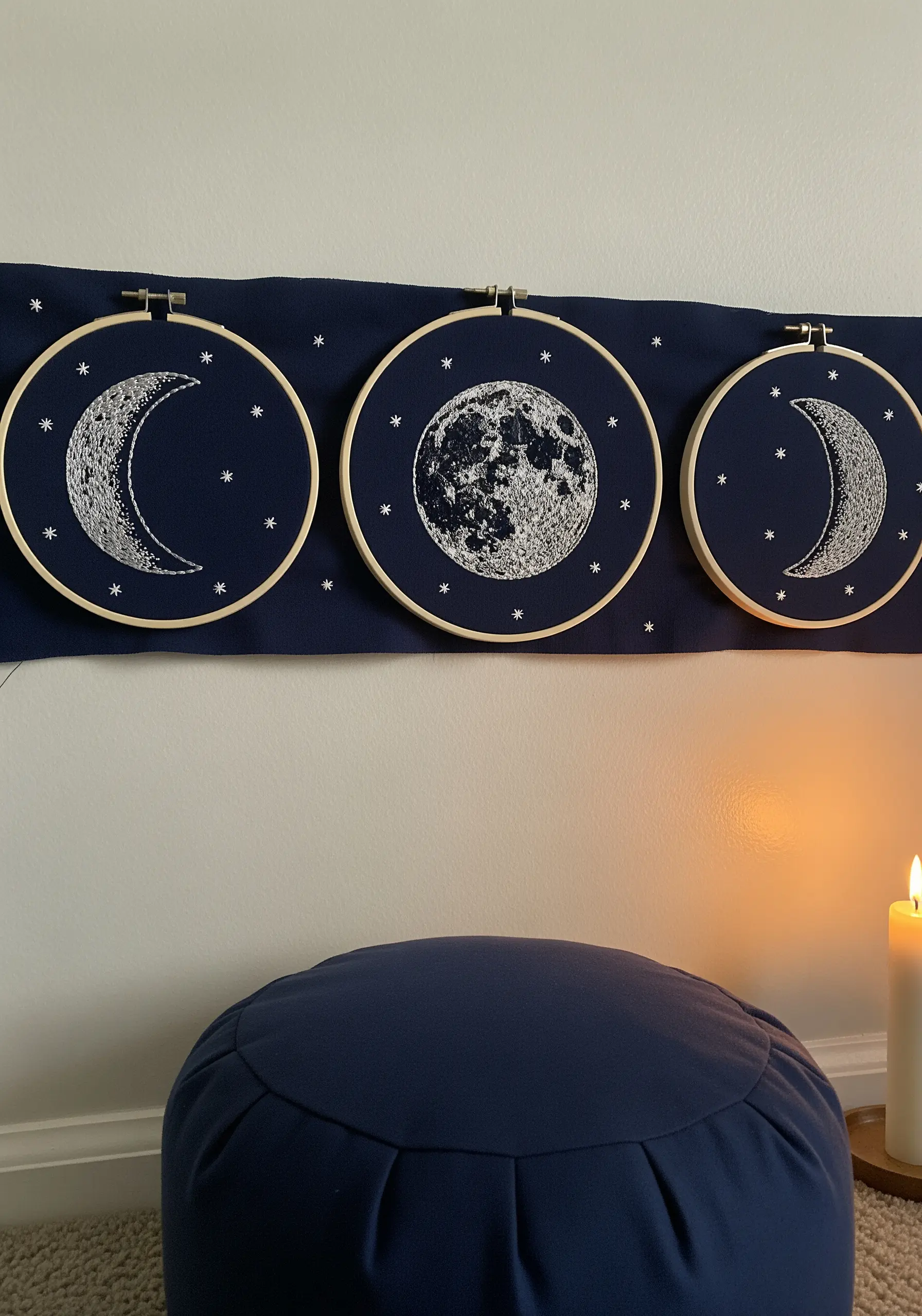 Three embroidery hoops depicting moon phases with dense French knot textures.