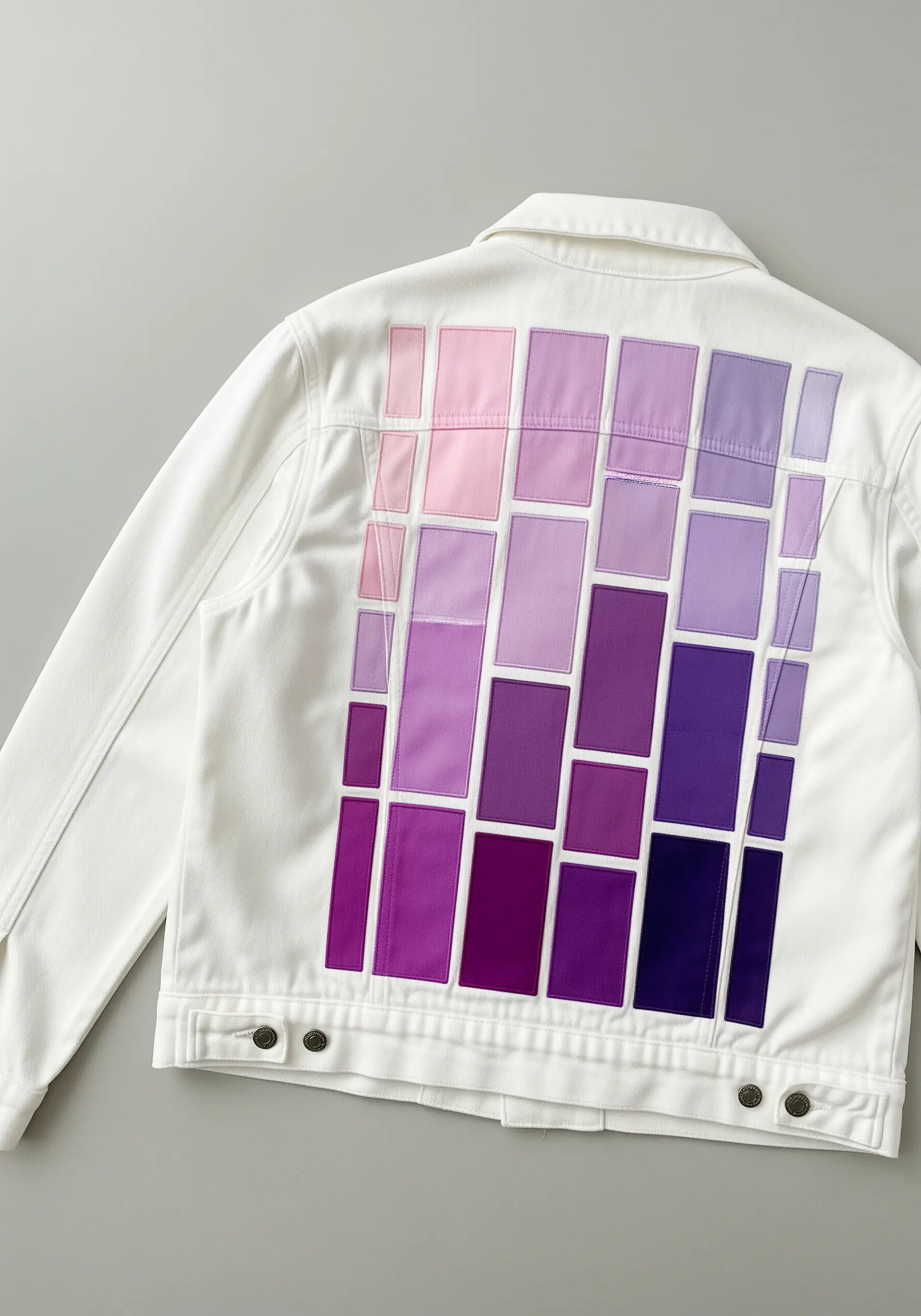 A mosaic of purple fabric appliqué rectangles arranged in a light-to-dark gradient.