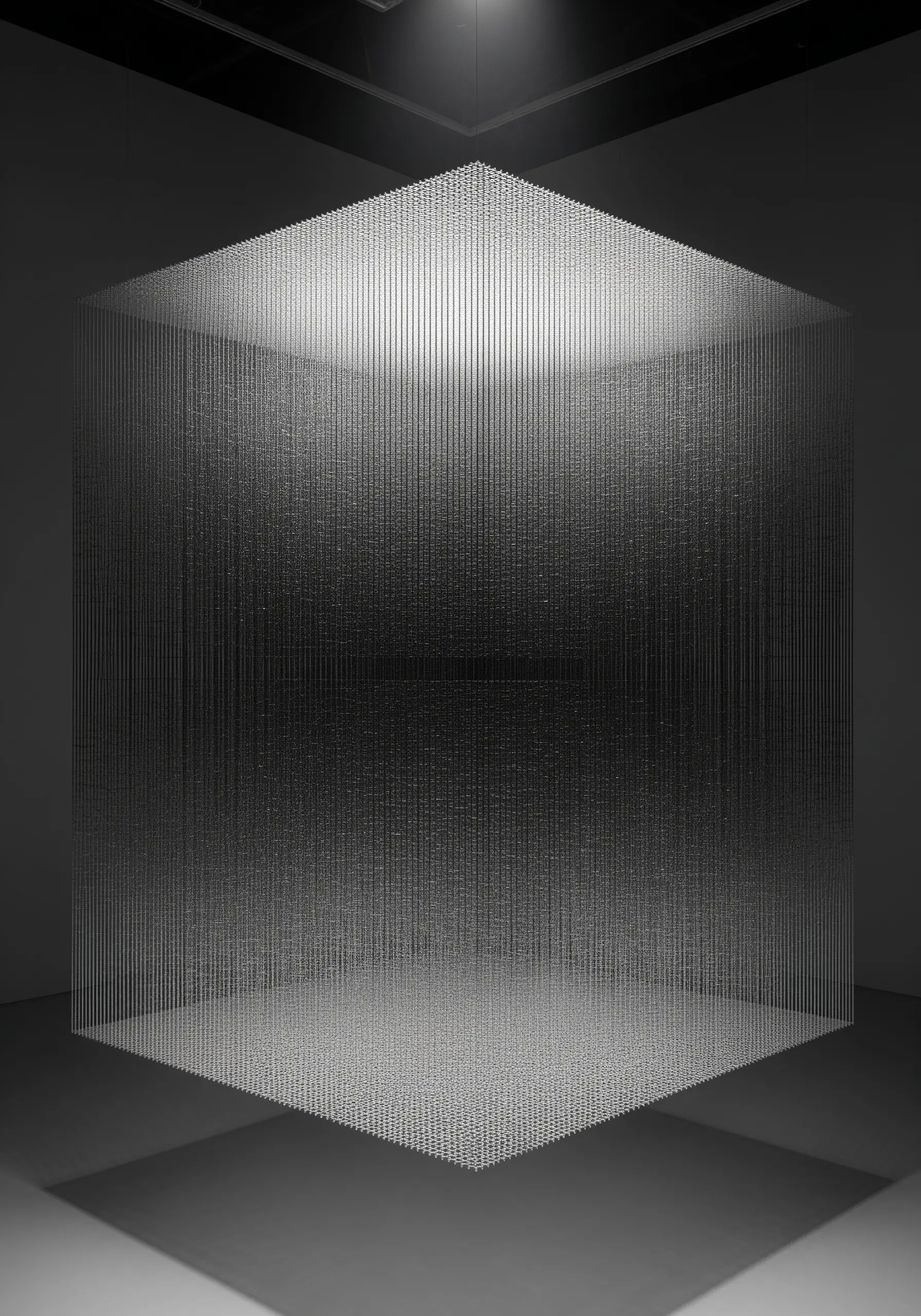 A cube of light is formed by thousands of tiny, suspended points, creating a shimmering, translucent shape.