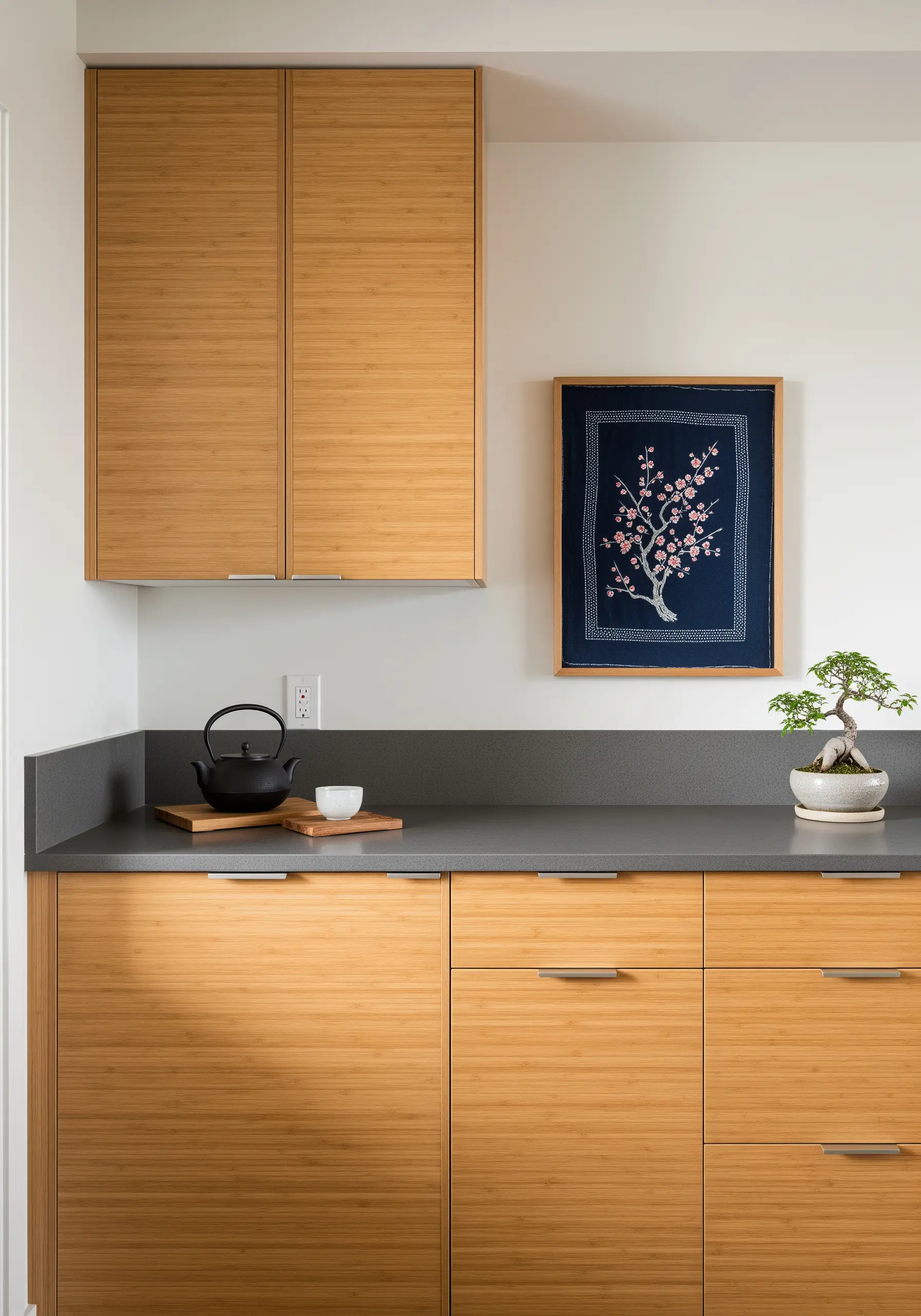 Japanese-inspired embroidery of a cherry blossom tree on indigo fabric, in a modern kitchen.