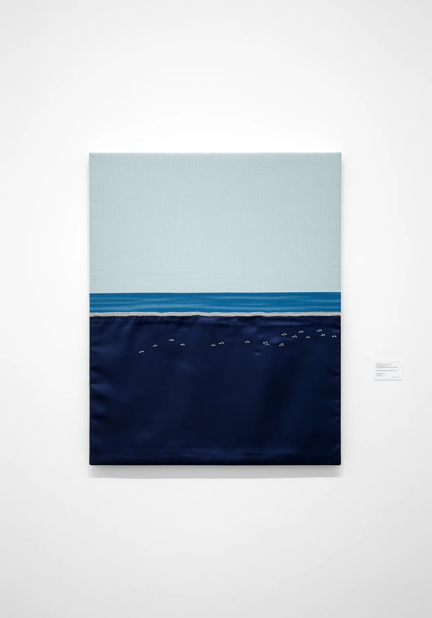 A minimalist seascape using two blocks of fabric—light blue linen and dark blue silk.