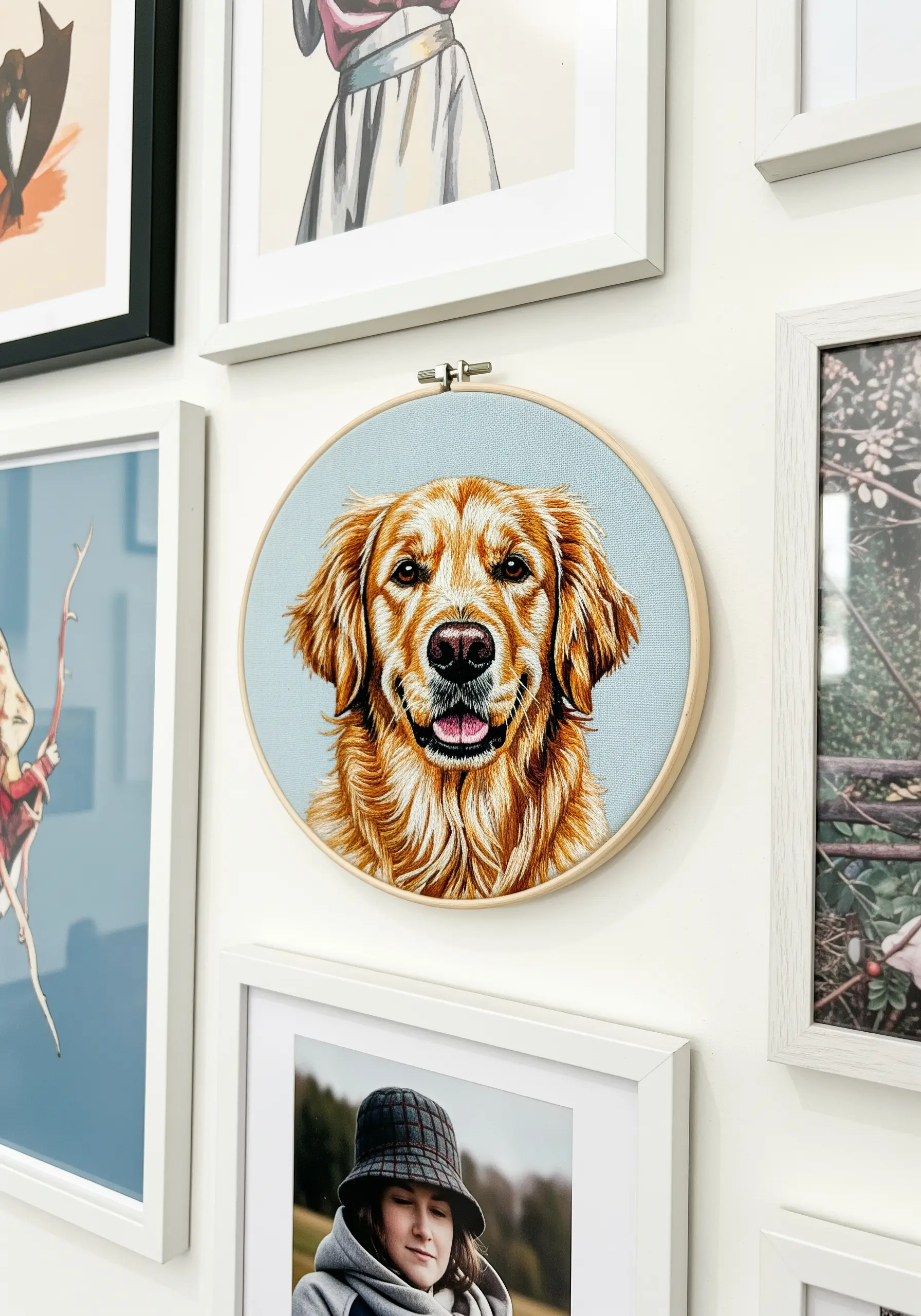 A highly realistic embroidered portrait of a golden retriever on light blue fabric.
