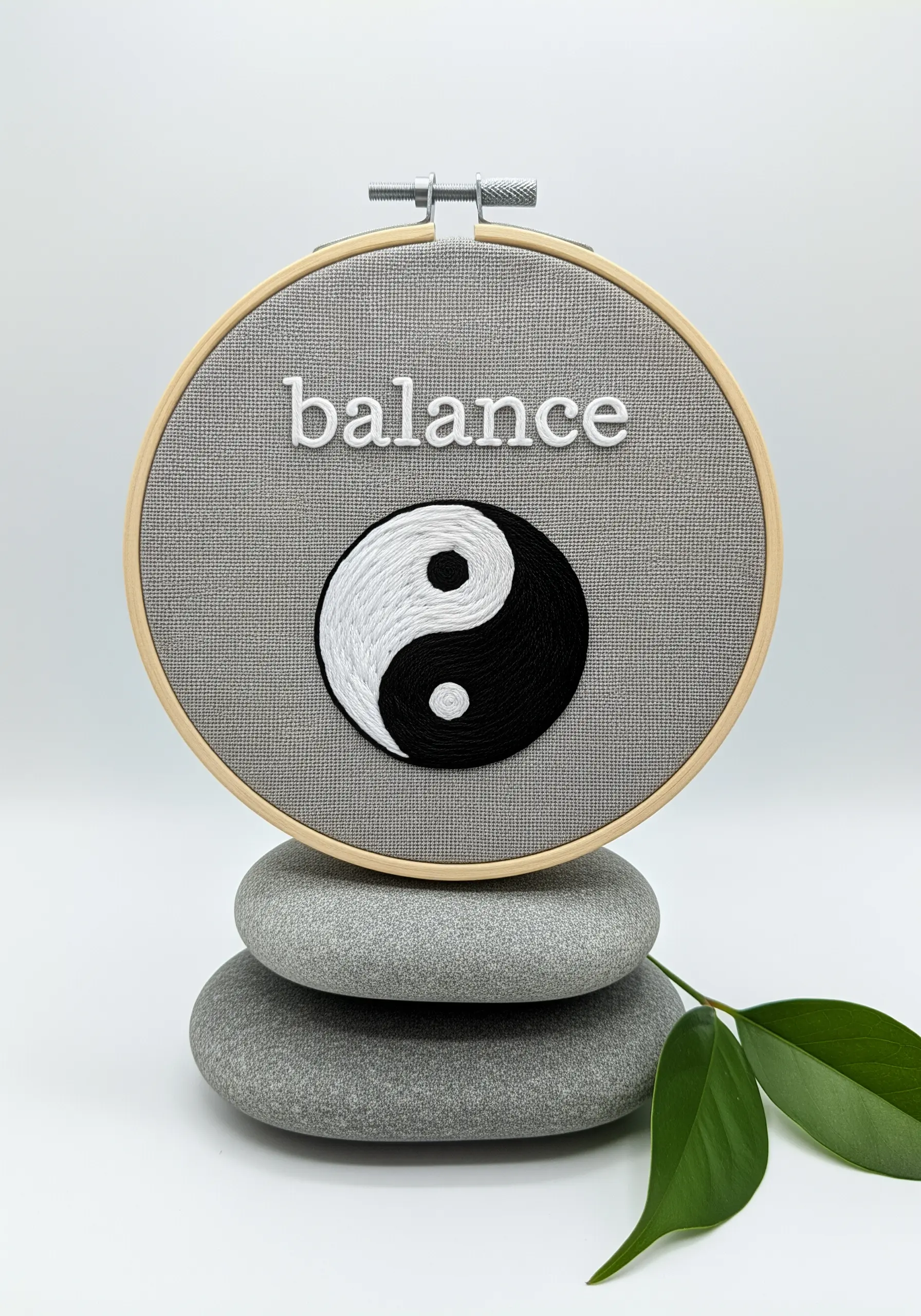 A perfectly balanced yin-yang symbol stitched in black and white raised satin stitch
