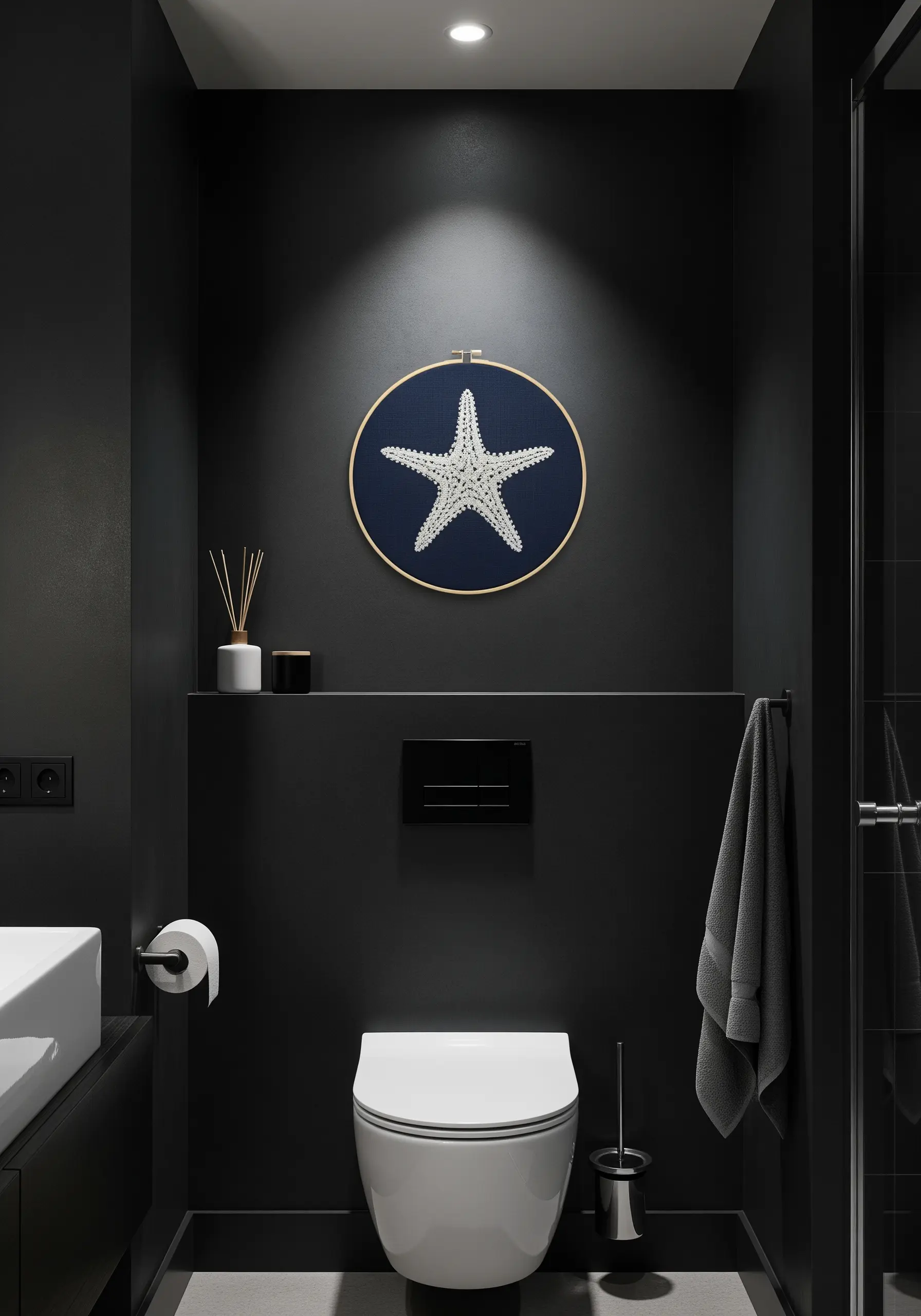 A white, heavily textured embroidered starfish stands out against a dark navy fabric in a hoop.