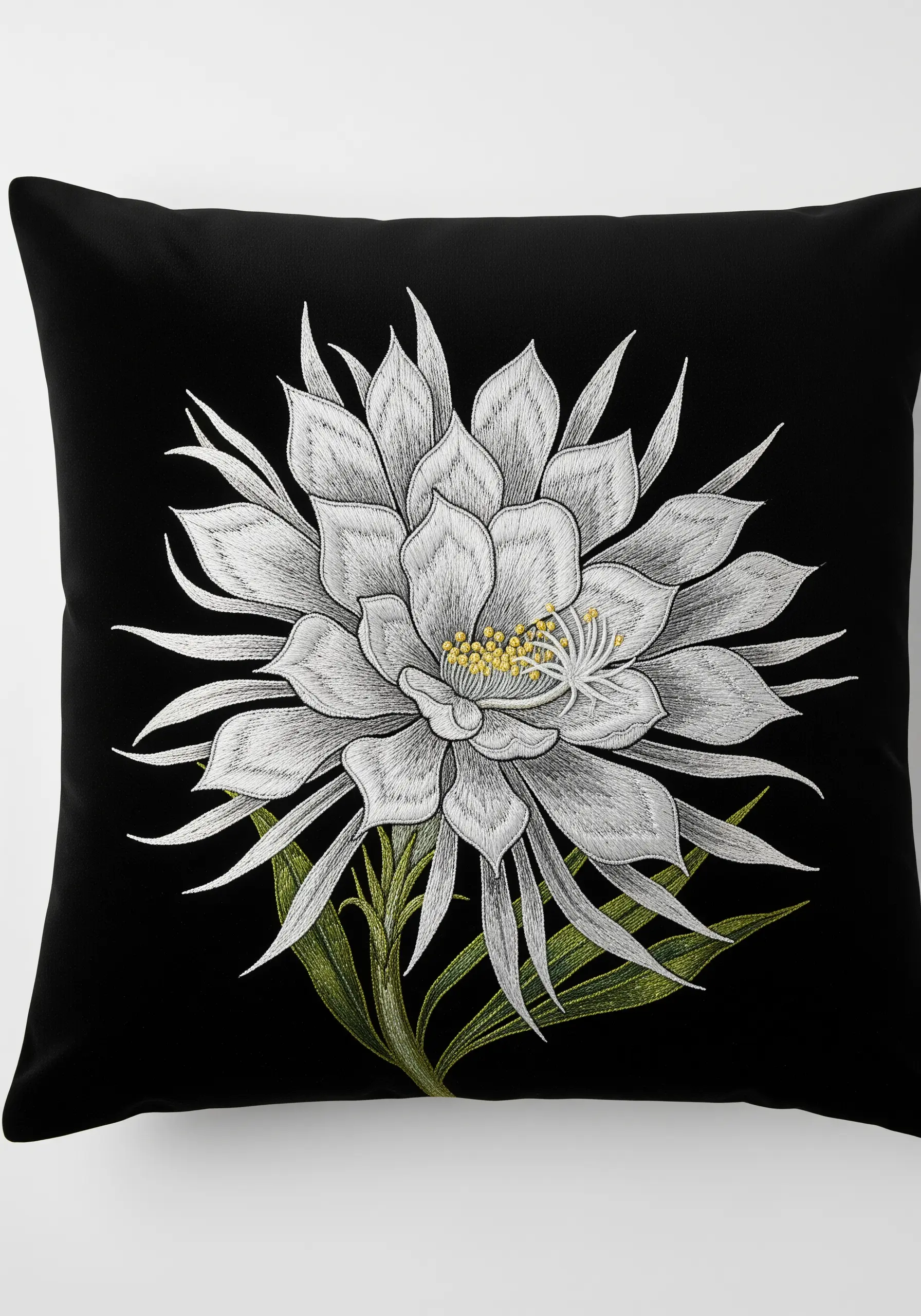 A large, white night-blooming cereus flower embroidered in detail on a black pillow.