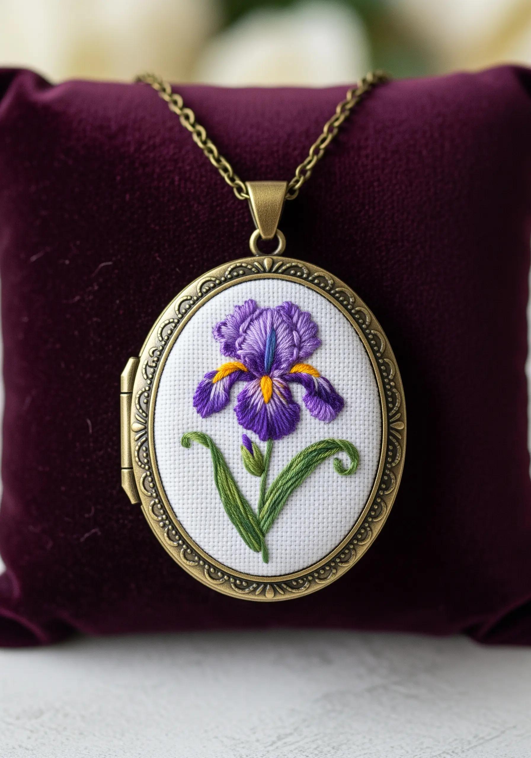 Miniature thread-painted iris flower inside an antique-style locket.