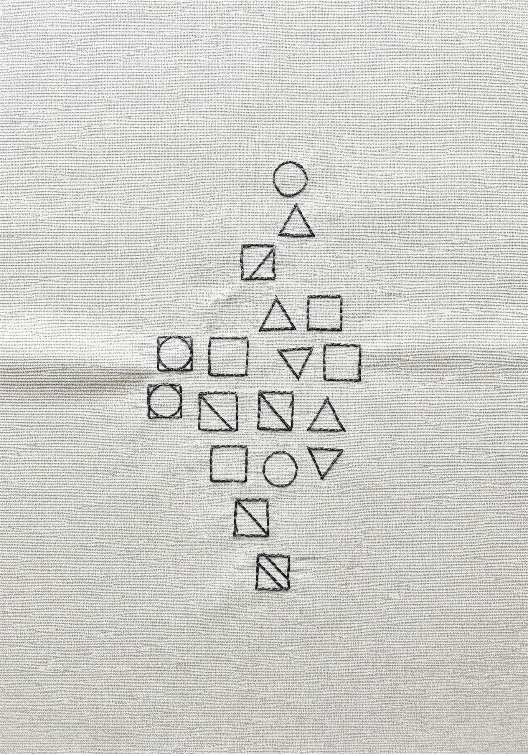 A collection of small, geometric shapes (circles, squares, triangles) outlined in black thread.