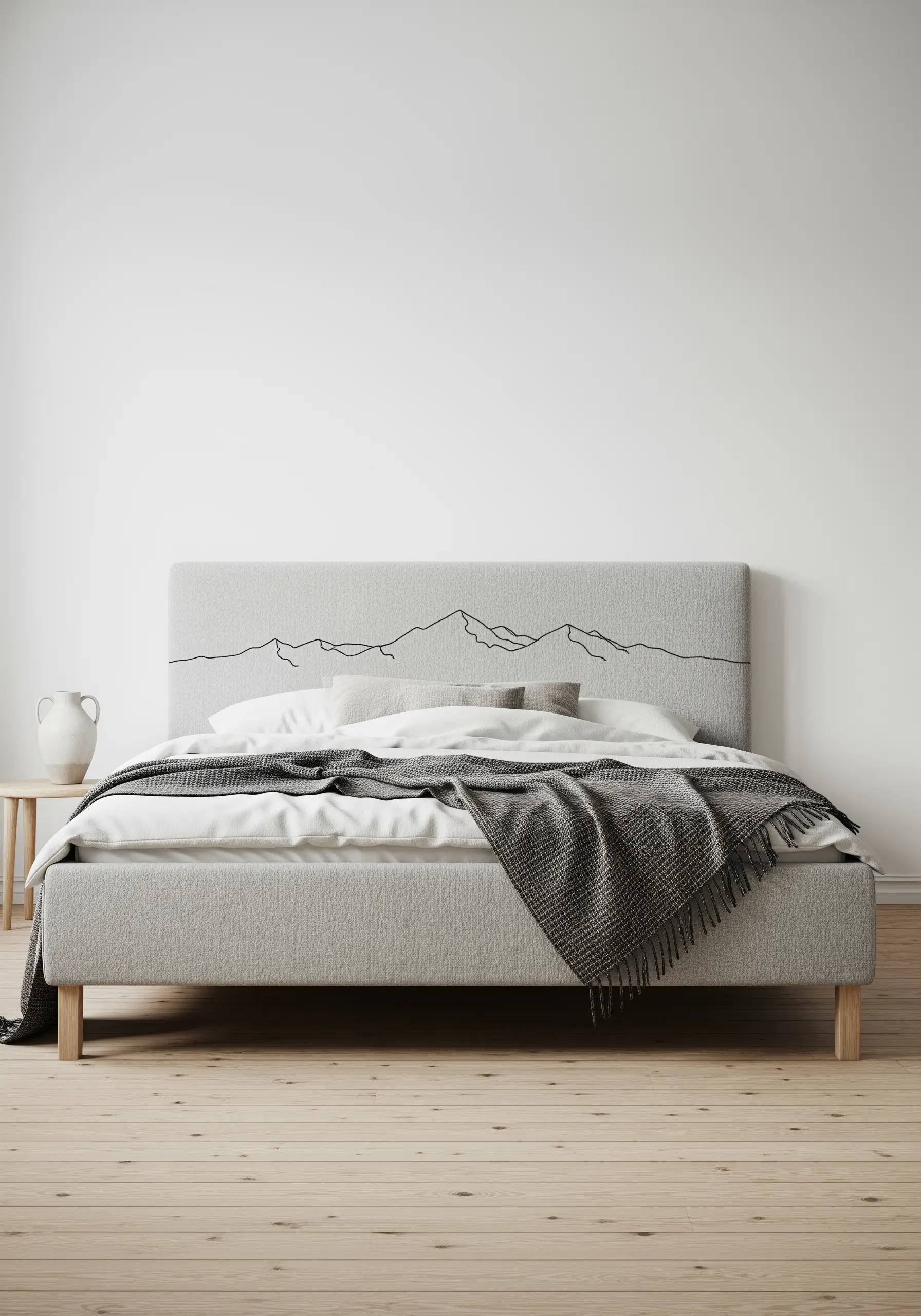 Minimalist grey headboard with a single black embroidered line depicting a mountain range.