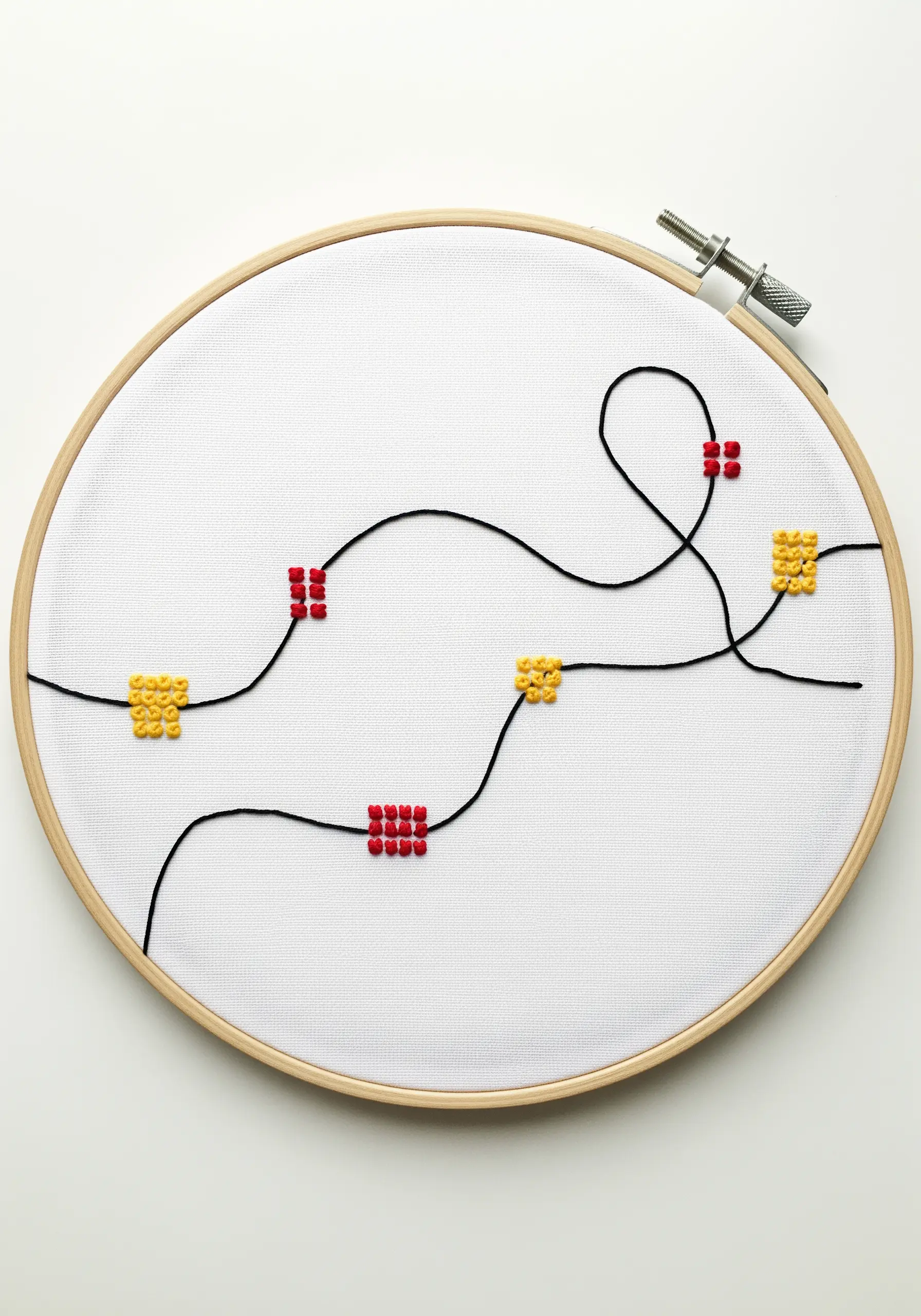 A minimalist design with a single black thread line punctuated by small red and yellow cross-stitch squares.