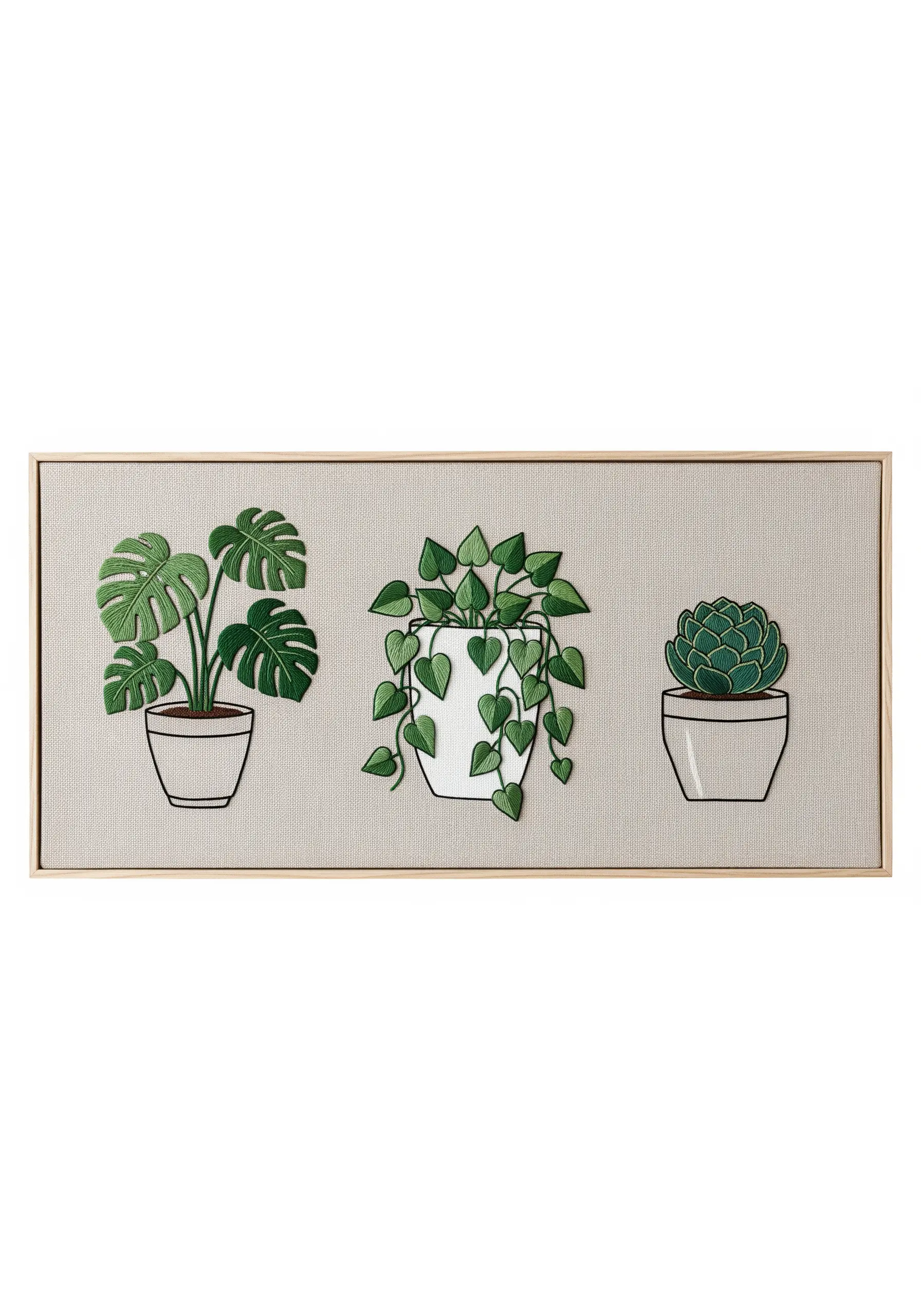 A framed triptych of three embroidered houseplants: a Monstera, a Pothos, and a succulent.