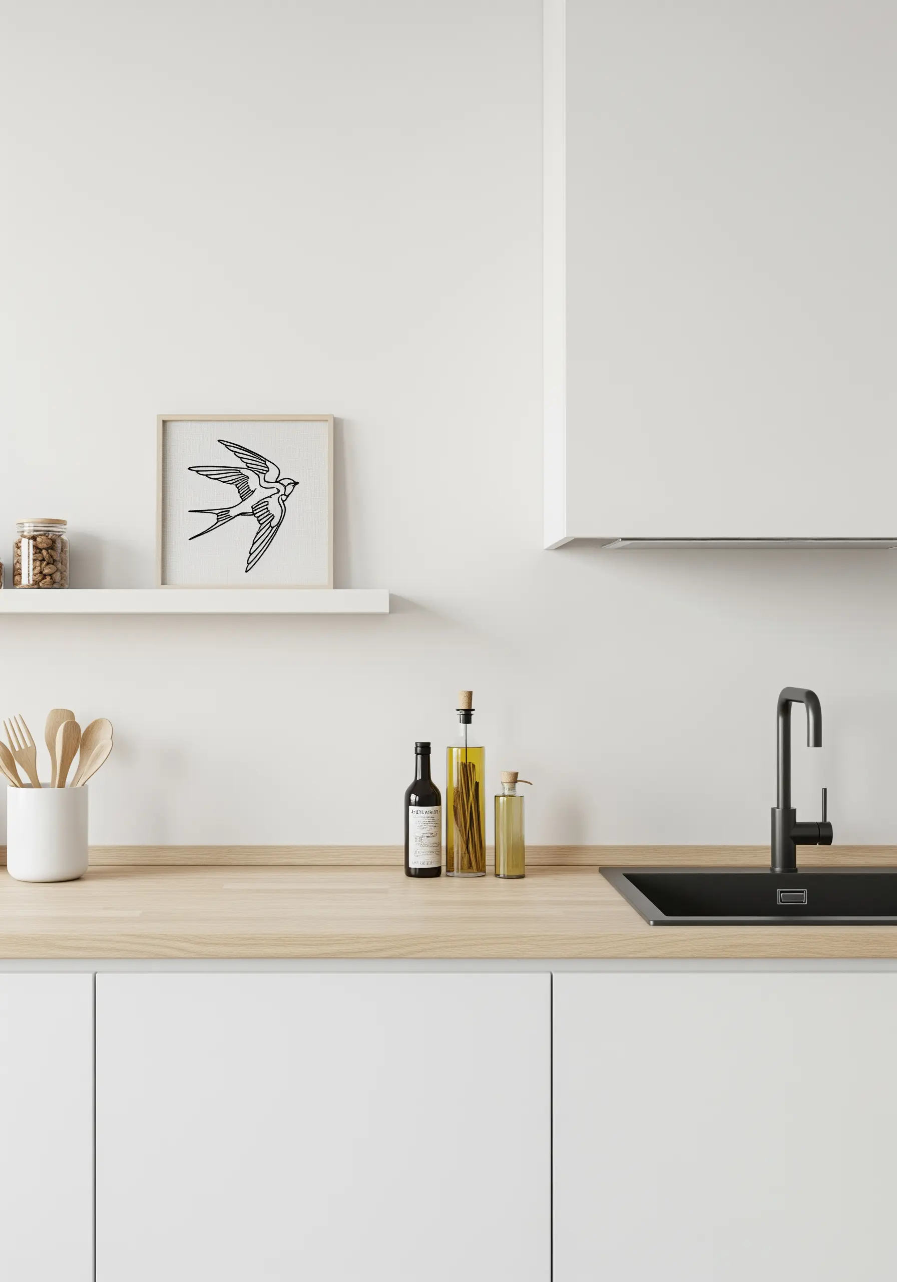 A minimalist cross-stitch of a swallow in black thread, framed in a modern kitchen.