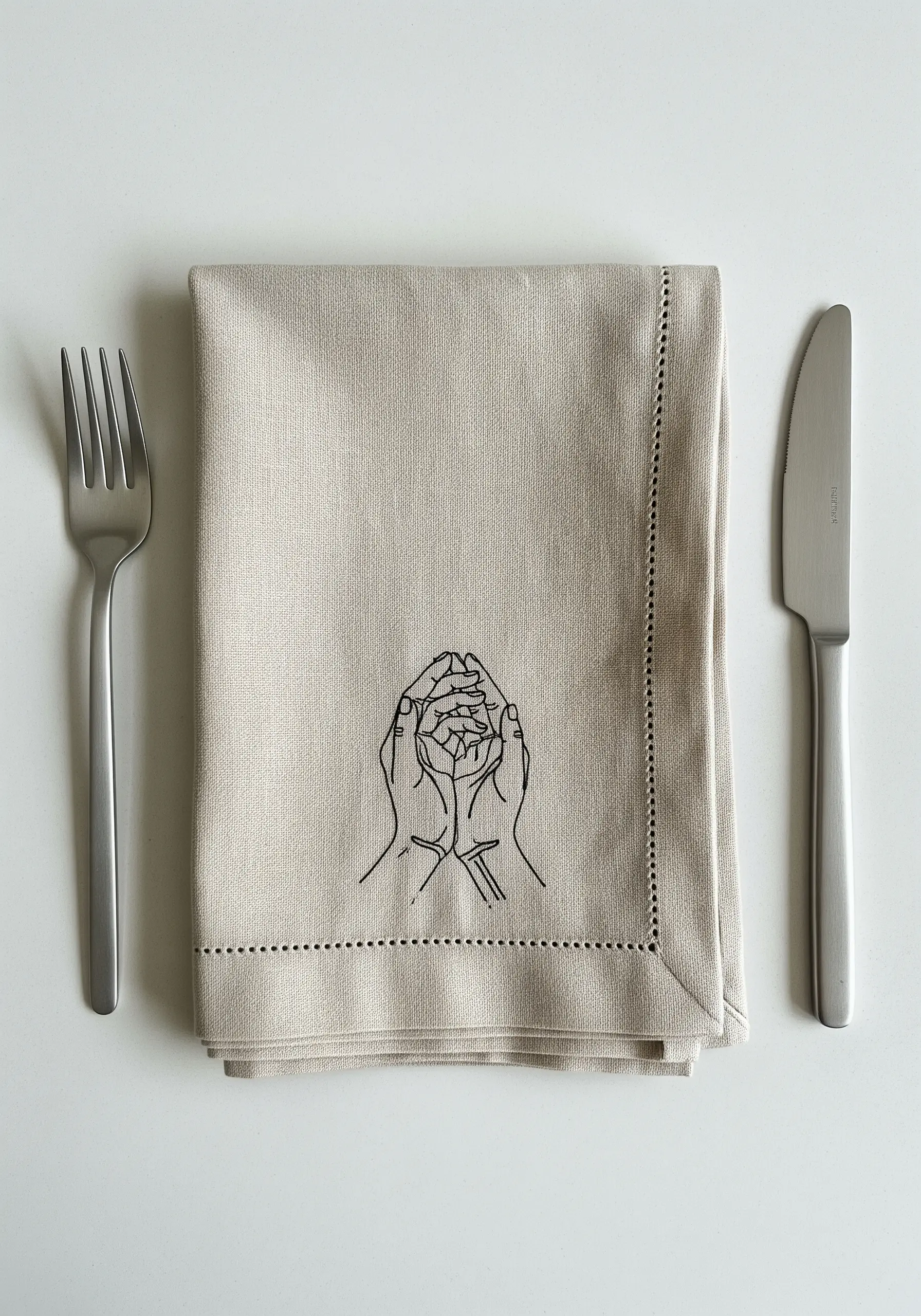 Line art of hands playing cat's cradle, stitched in black on beige linen.